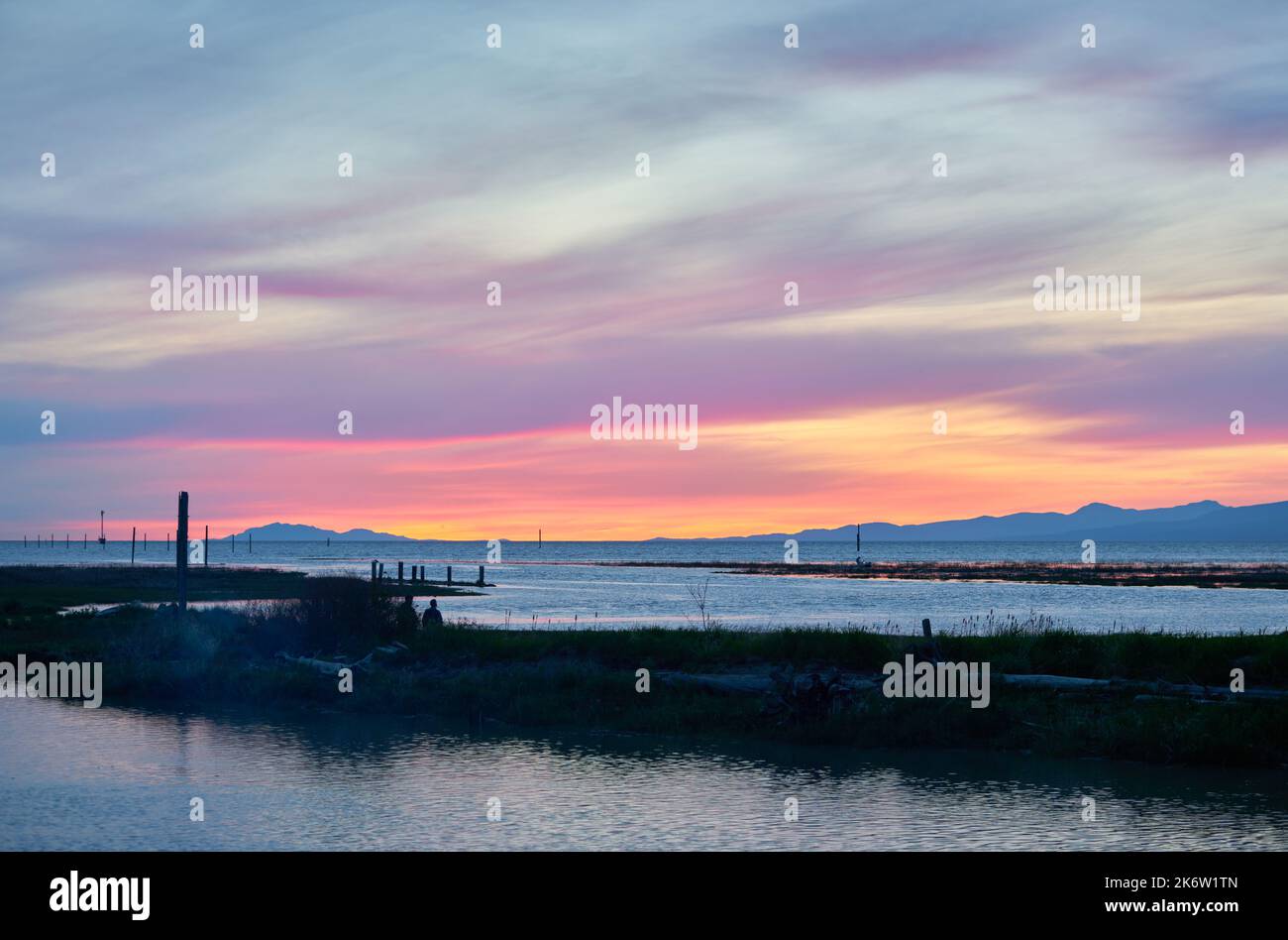 Salish Sea Sunset. The sunset over the Georgia Strait and the Salish Sea from the mouth of the Fraser River. Stock Photo