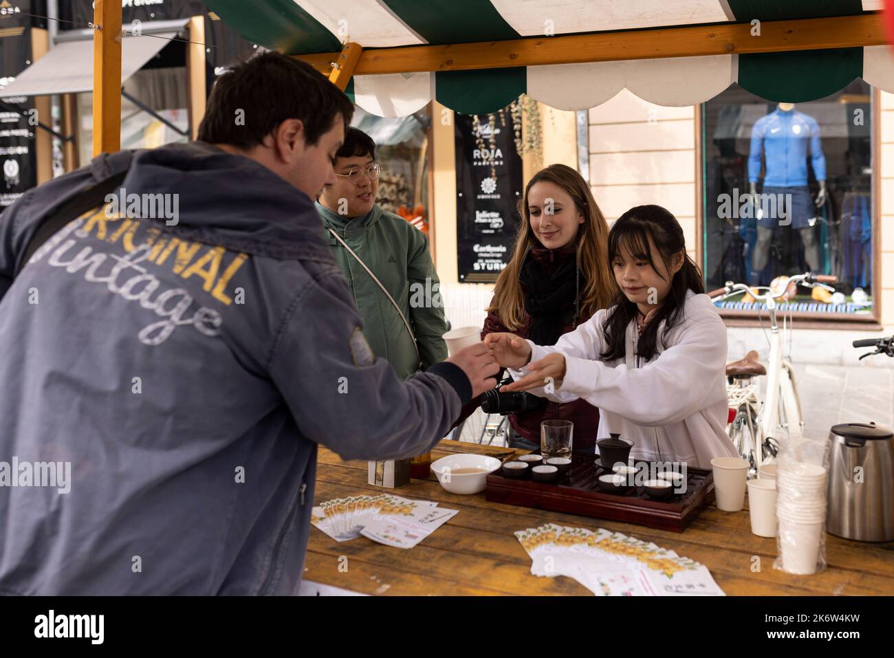 Ljubljana, Slovenia. 15th Oct, 2022. A staff member serves a cup of Chinese tea to a visitor at a charity event in Ljubljana, Slovenia, Oct. 15, 2022. The Confucius Institute in Ljubljana on Saturday showcased Chinese culture at a charity event held in the capital of Slovenia. Visitors had the chance to taste Chinese tea, experience Chinese calligraphy, and put on Hanfu, traditional Chinese clothing, to take photos at the event, which aims at raising fund for Slovenian children in need. Credit: Zeljko Stevanic/Xinhua/Alamy Live News Stock Photo