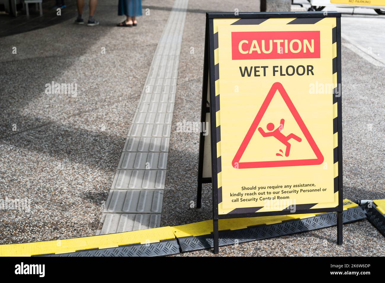 Sign showing warning of caution wet floor on the pathway Stock Photo