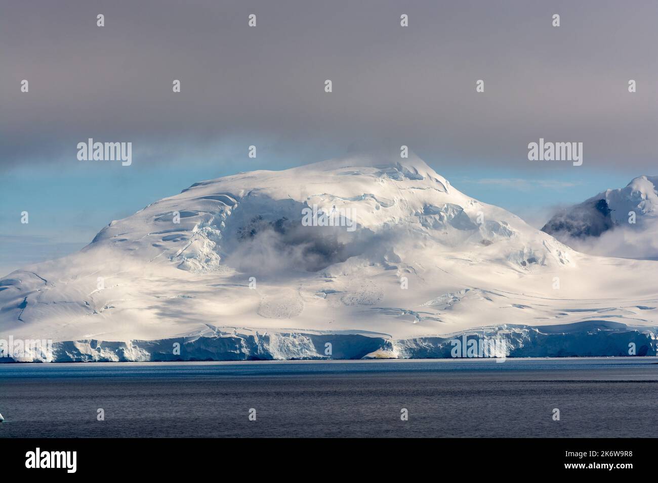 snow and cloud covered peak at the southern end of fief mountains on wiencke island. looking from gerlache strait. antarctic peninsula. antarctica Stock Photo