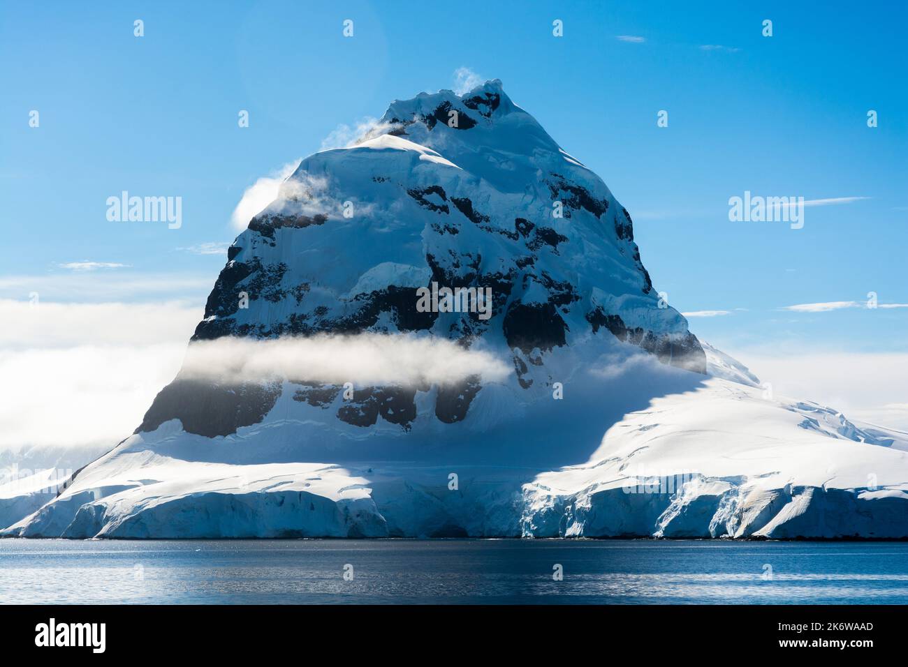 dayné (dayne) peak at the southern end of fief mountains on wiencke island. looking from bismarck strait with cape errera in the foreground. antarctic Stock Photo