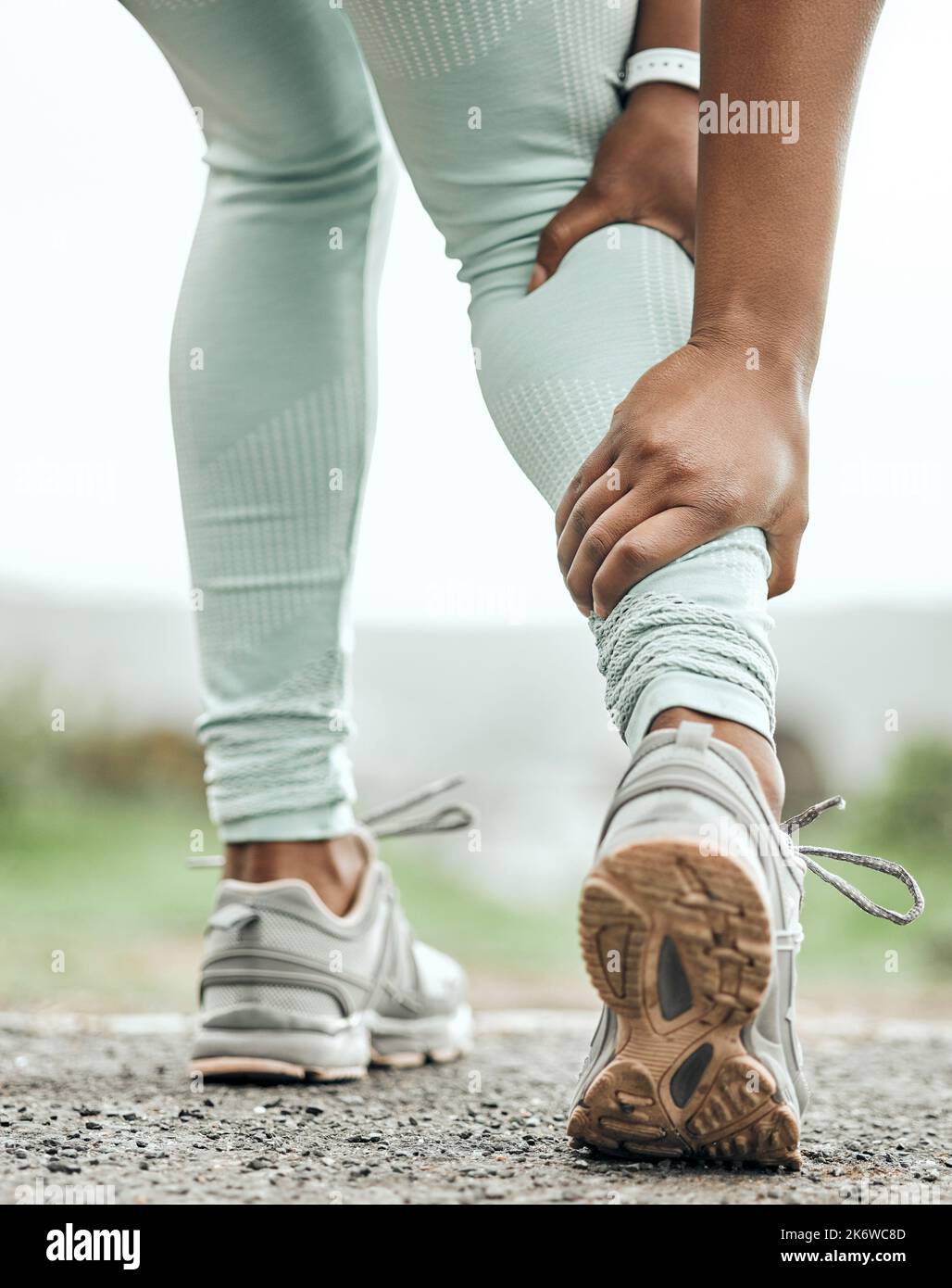 Ive got another cramp. an unrecognizable person holding their leg in