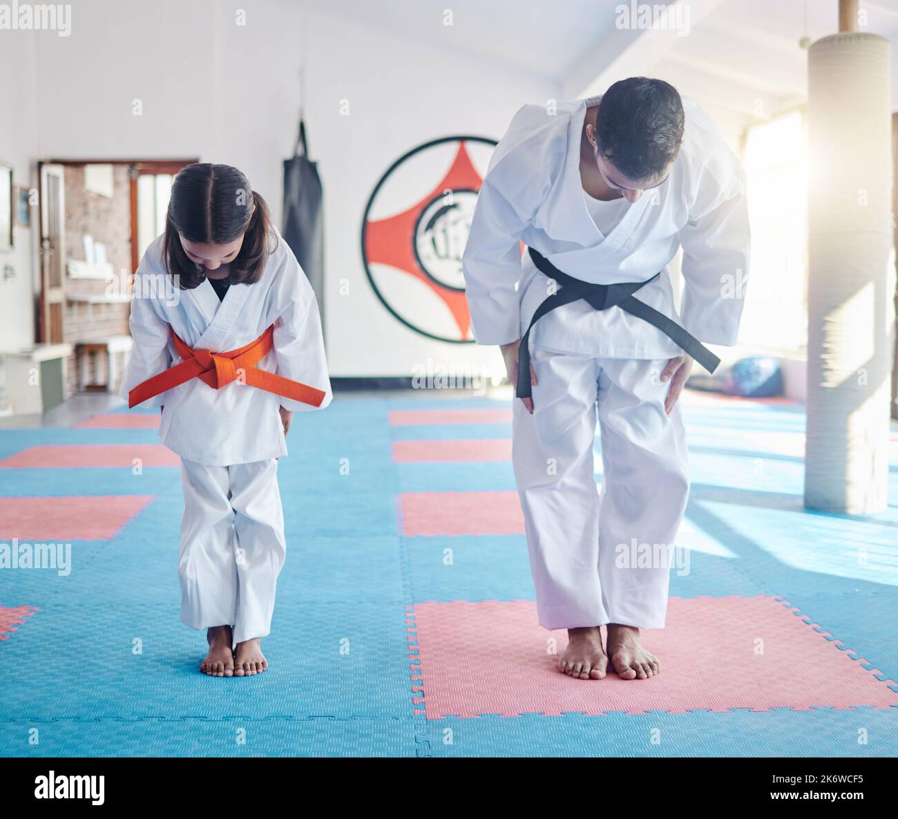 Give respect, get respect. a young man and cute little girl practicing karate in a studio. Stock Photo
