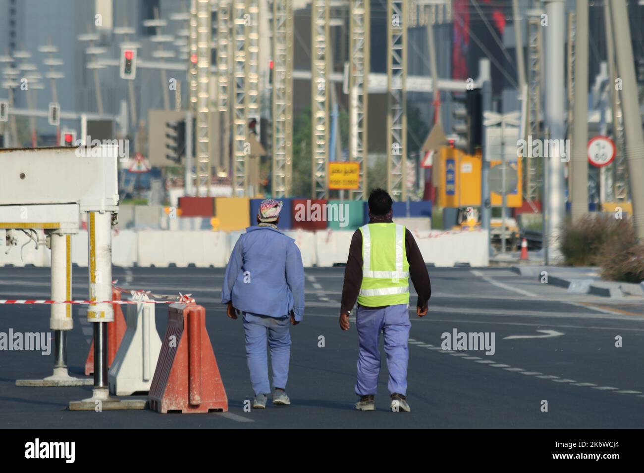 A view of two workers walking on the streets of FIFA 2022 Fan Village Stock Photo