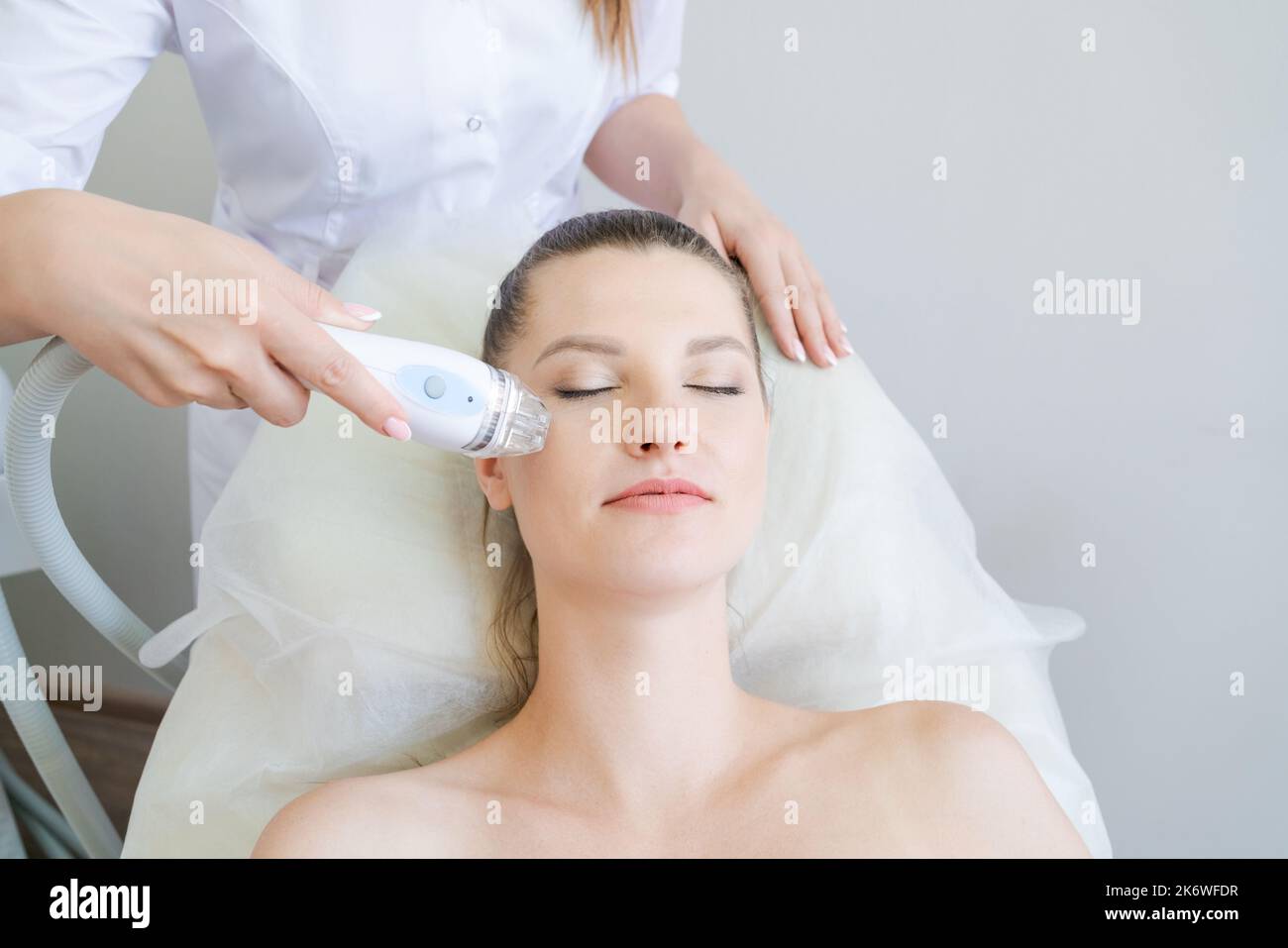 woman in beauty clinic receives nonsurgical face lift. SMAS