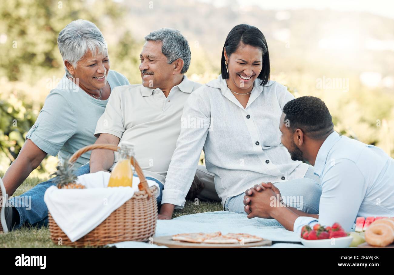 Happiness is having a large, loving family. a family enjoying a picnic in a park. Stock Photo