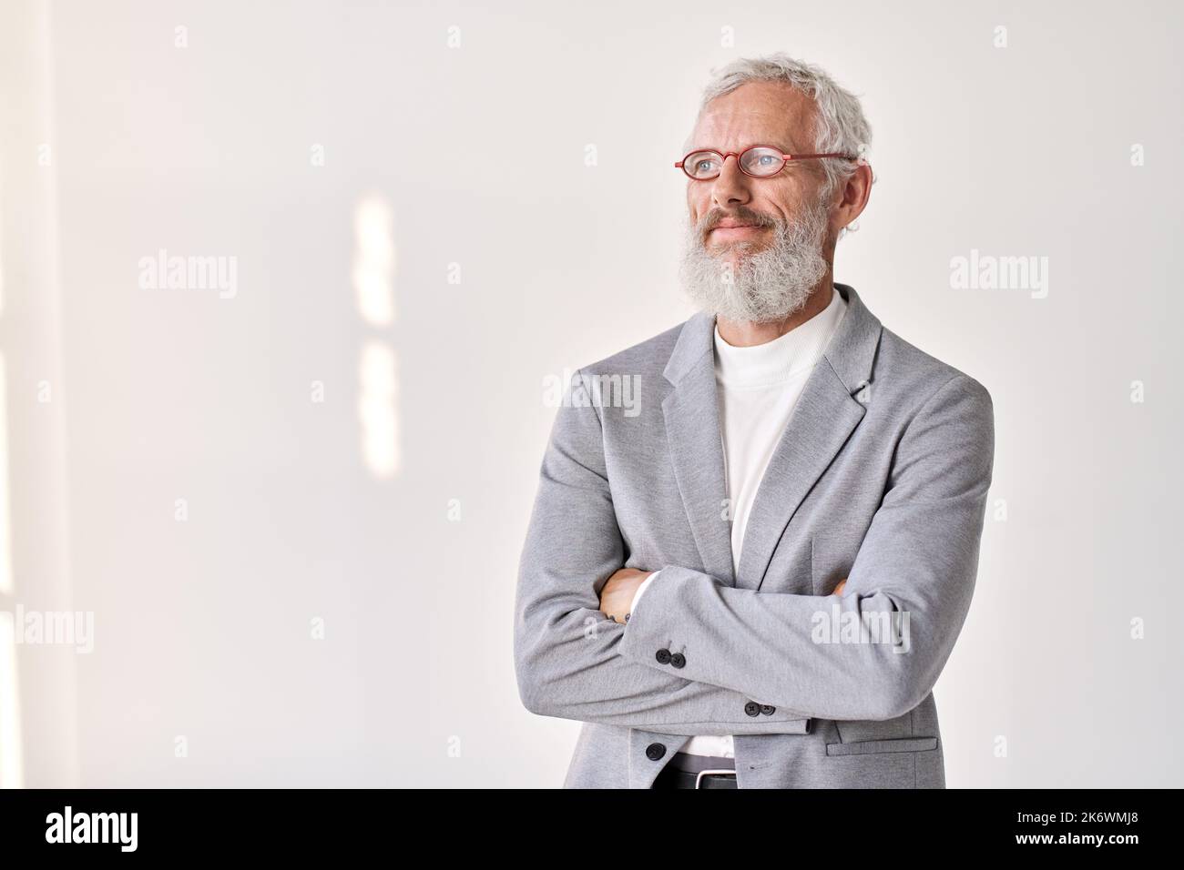 Smiling senior older business man looking away isolated on white, portrait. Stock Photo