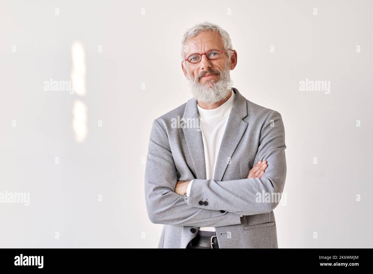 Confident senior older business man isolated on white wall, portrait. Stock Photo