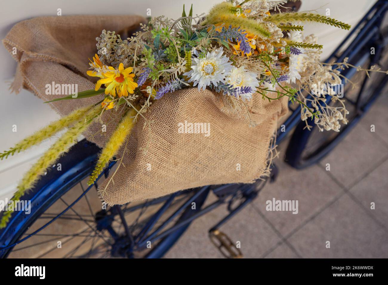 Field flower bouquet in a burlap bag Stock Photo
