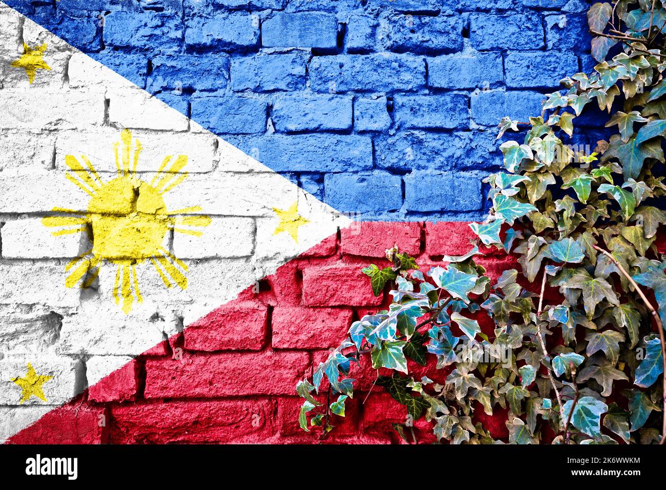Philippines grunge flag on brick wall with ivy plant, country symbol concept Stock Photo