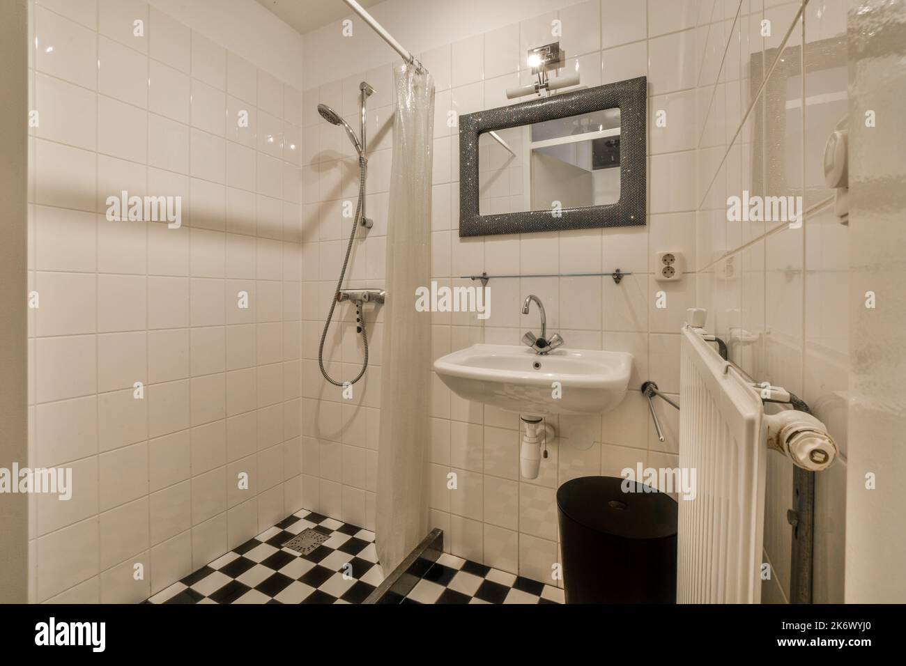 Glass partition between shower tap and wall hung toilet in modern