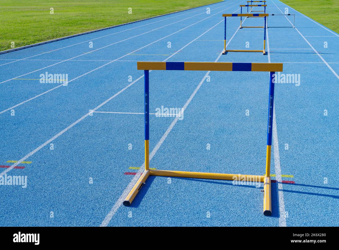 Hurdles on running track in stadium Stock Photo Alamy