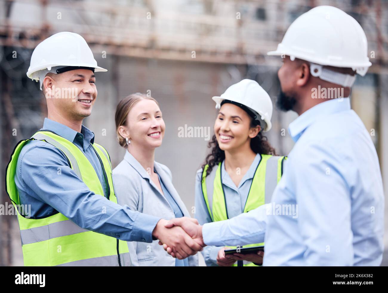Great partnerships start with a smile. two architects shaking hands at ...