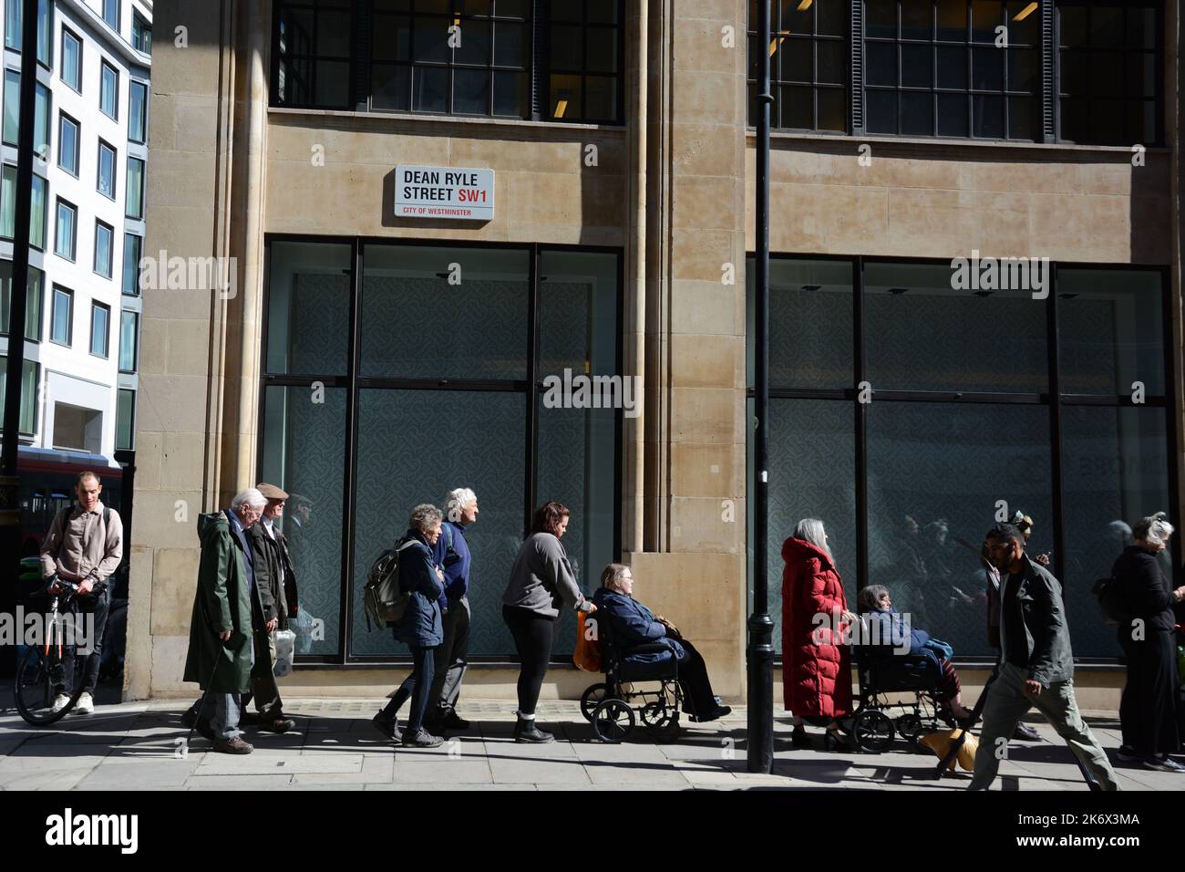 Patient people with accessibility requirements queue to see the coffin ...