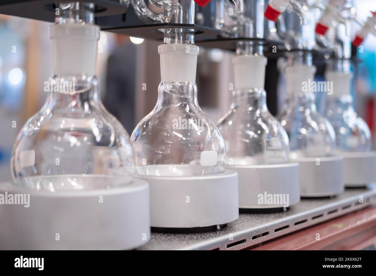 Laboratory equipment empty glass vials on heating mantle in row Stock