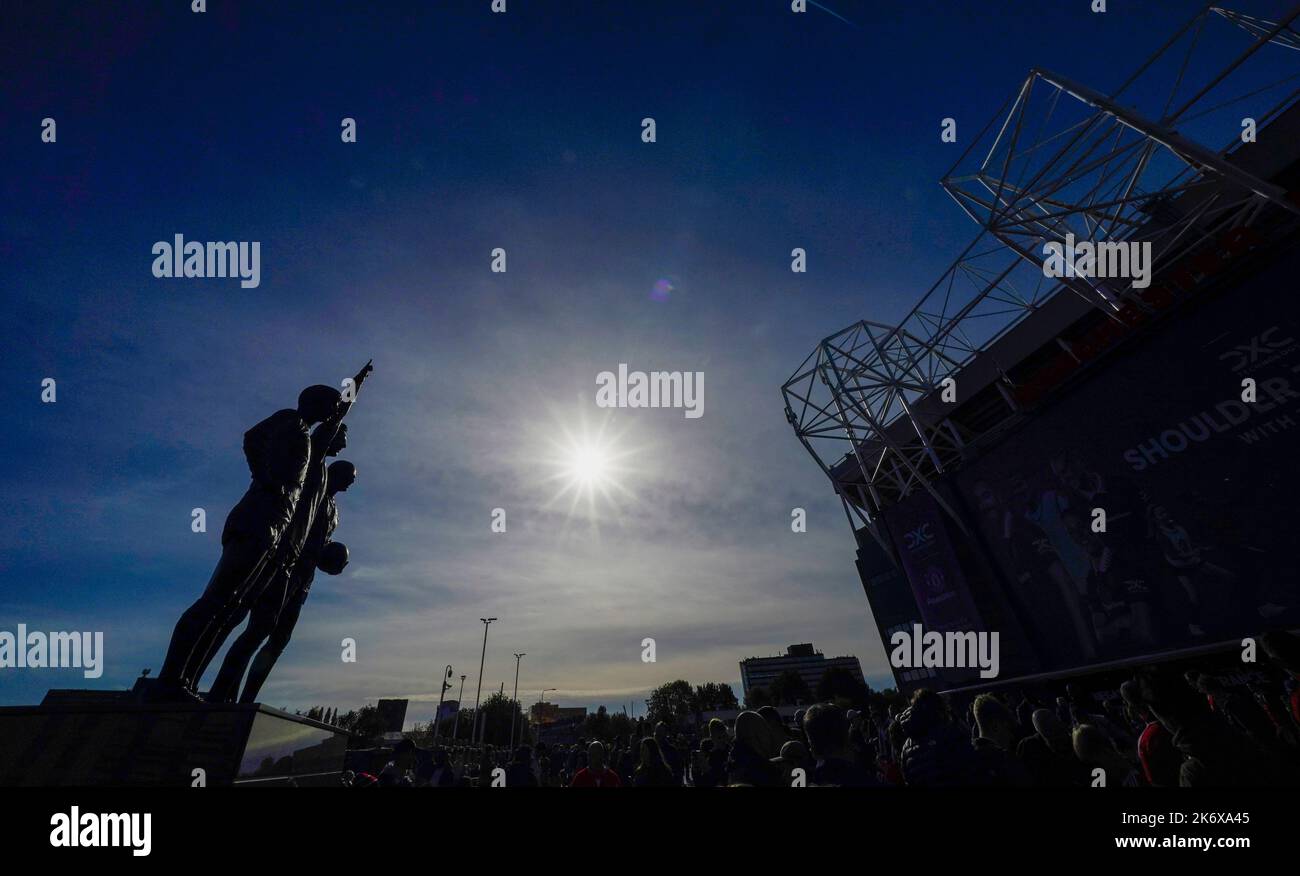 Manchester, UK. 16th Oct, 2022. The United Trinity statue of Sir Bobby Charlton, George Best and Denis Law silhouetted against a clear sky before the Premier League match at Old Trafford, Manchester. Picture credit should read: Andrew Yates/Sportimage Credit: Sportimage/Alamy Live News Stock Photo