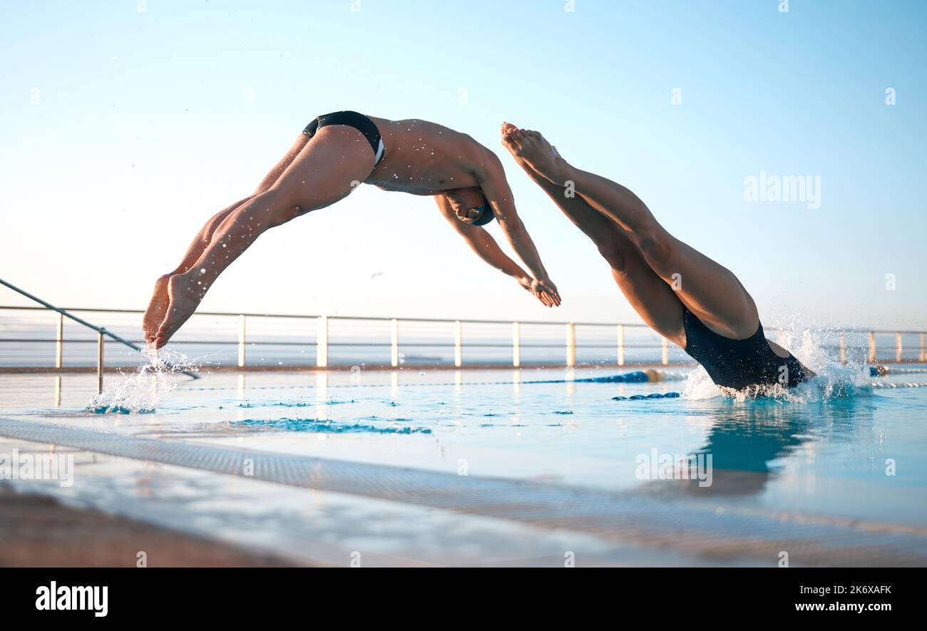 Dive right in. two young athletes diving into an olypmicsized swimming