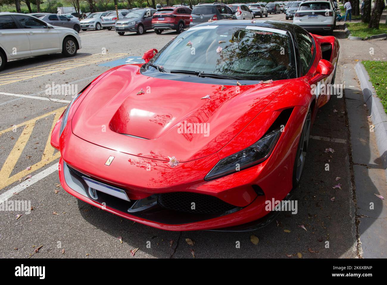 Atibaia - Brazil, October 7, 2022: Top front side view of red Ferrari F8 Tributo parked. Mid-engined rear drive sports car. Ferrari is an Italian luxu Stock Photo