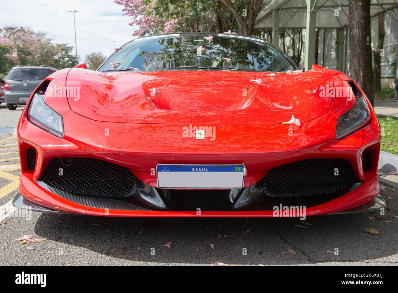 Atibaia - Brazil, October 7, 2022: Low front view of red Ferrari F8 Tributo parked. Mid-engined rear drive sports car. Ferrari is an Italian luxury sp Stock Photo