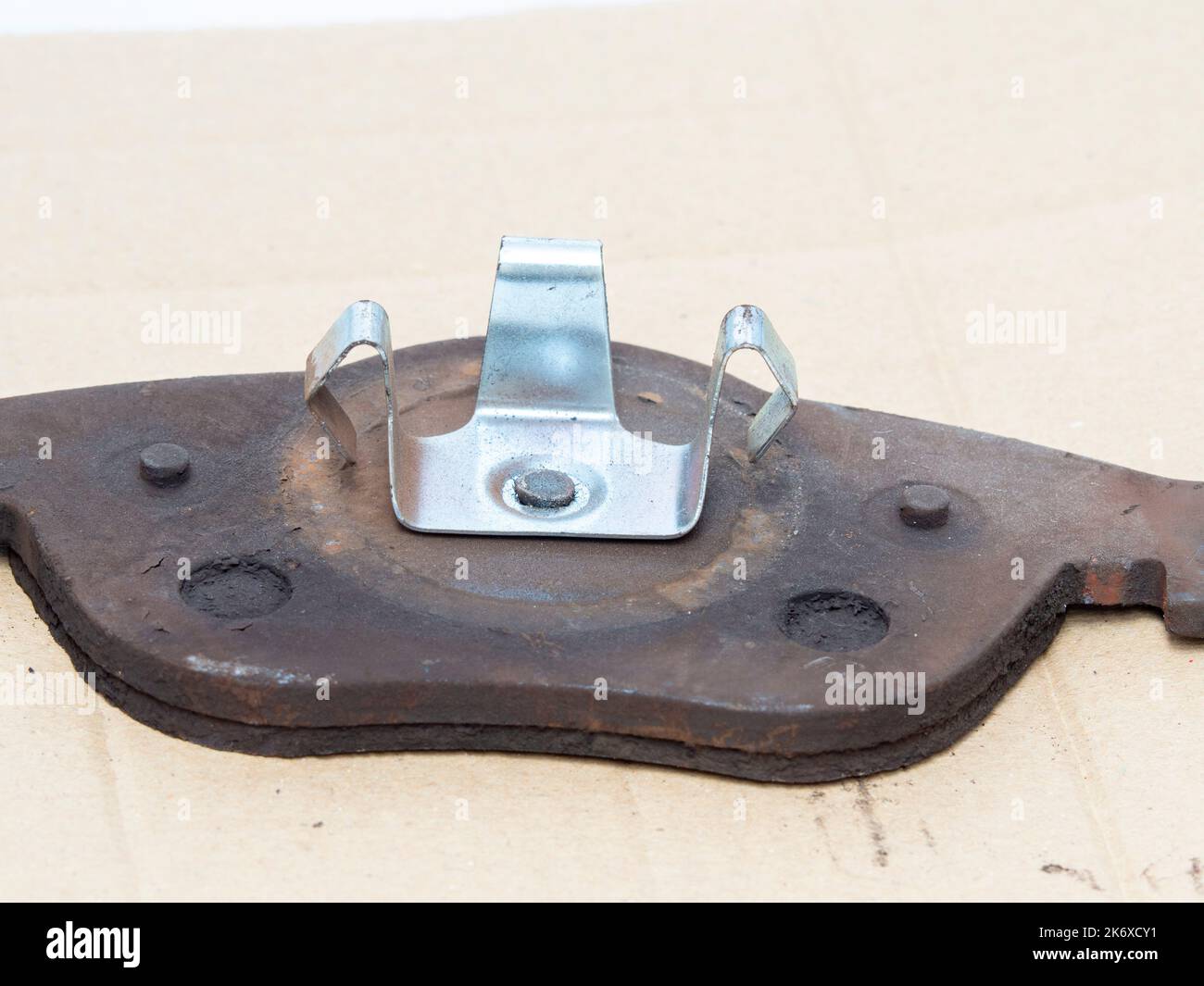 Used damaged brake pads need to change, close up. Stock Photo