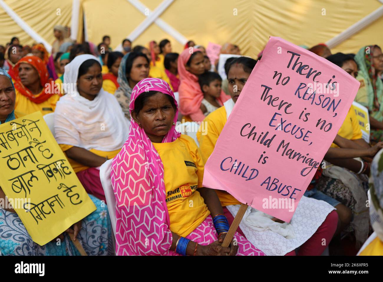 Sanjay Camp community people hold placards during ‘Child marriage-free India campaign’ held by an NGO at Sanjay Camp slum area in New Delhi in India on Sunday, October 16, 2022. More than 500 children and community women gathered to witness the campaign. India observes child girl marriages before the legal age due to lack of literacy amongst the people living in villages and slums. Photo by Anshuman Akash/ABACAPRESS.COM Credit: Abaca Press/Alamy Live News Stock Photo