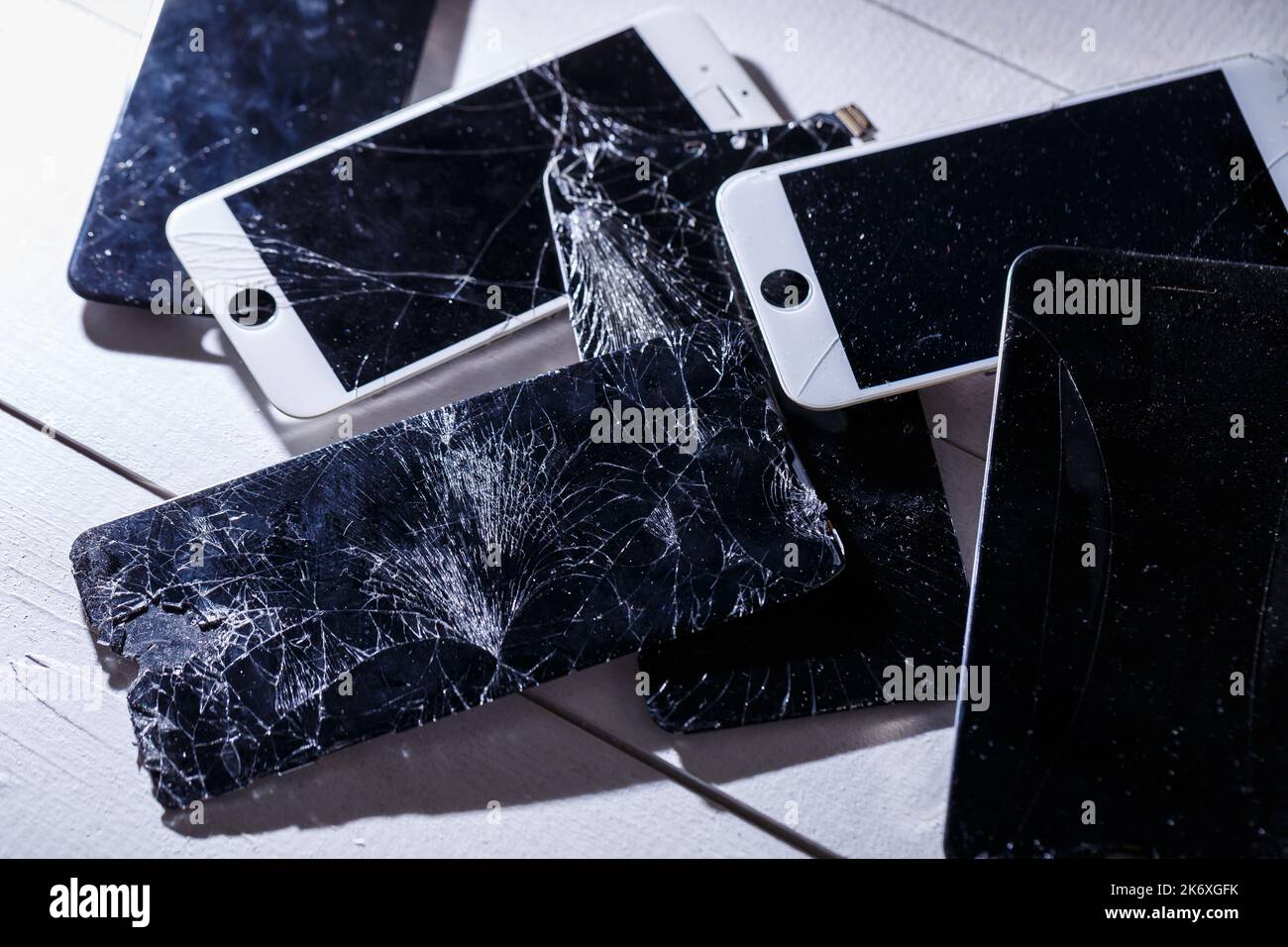 Mobile tablet device with a broken badly cracked shattered glass on the touch screen. Smart hardware part replacement, fixing concept Stock Photo