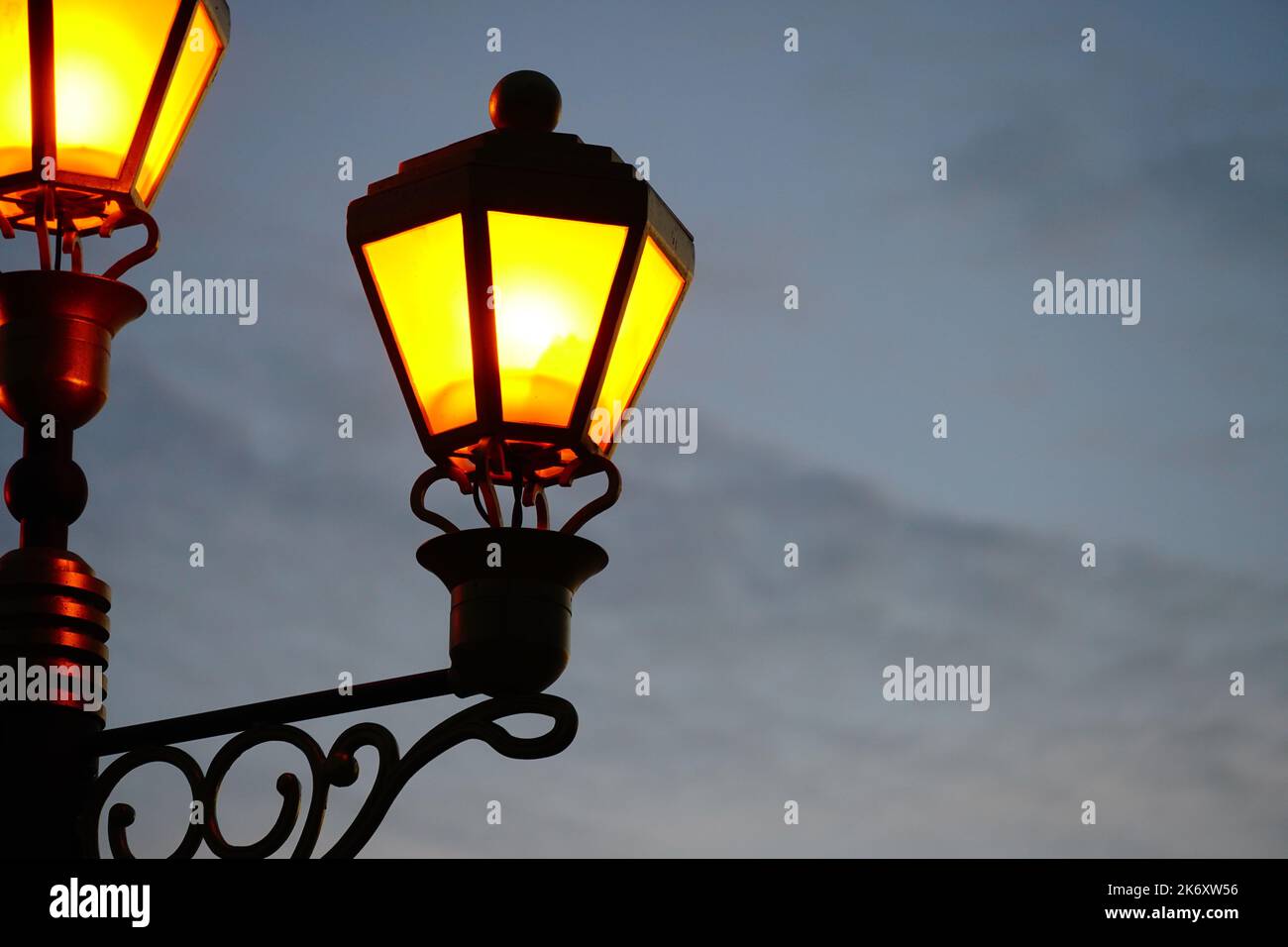 old lamps Light pole lantern shining in sunset sky Stock Photo - Alamy