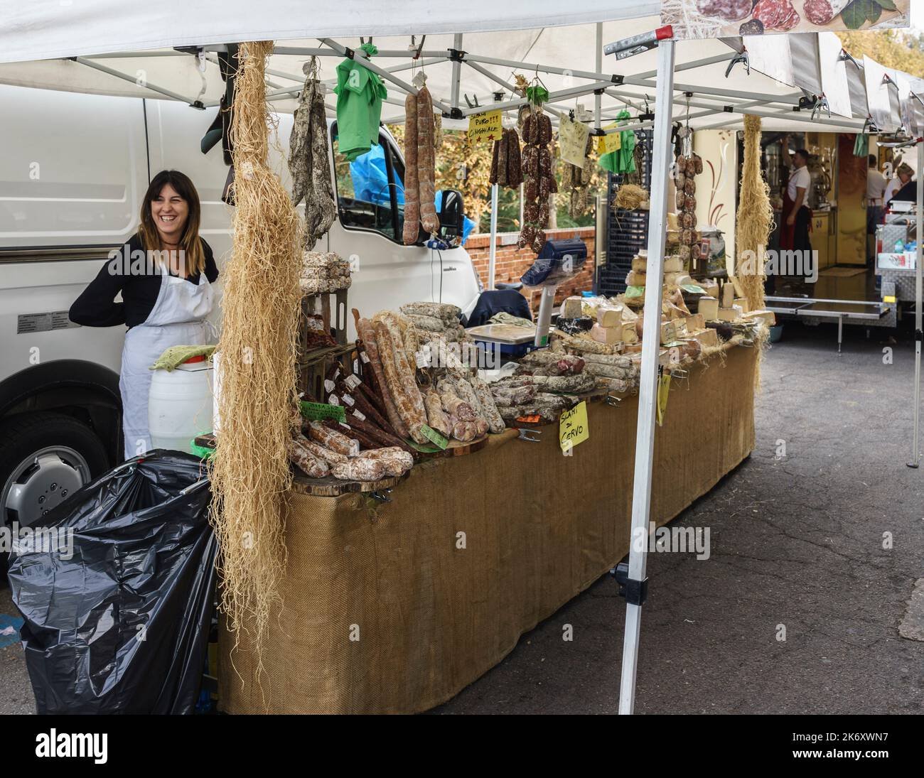 Alba, Piedmont, Italy - October 15, 2022: Stall selling cured meats and cheeses in a farmer's market. Stock Photo