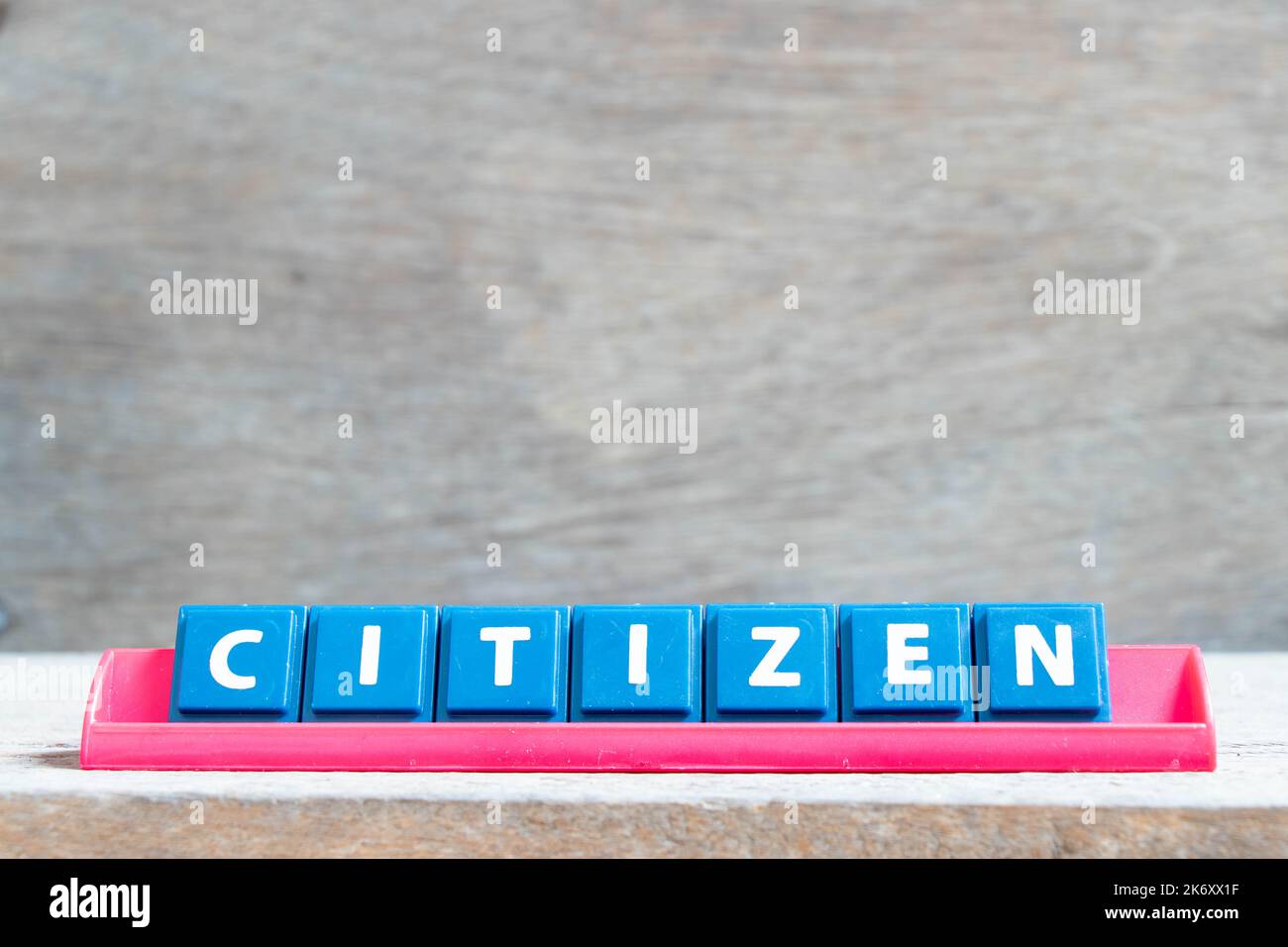 Tile alphabet letter with word citizen in red color rack on wood background Stock Photo