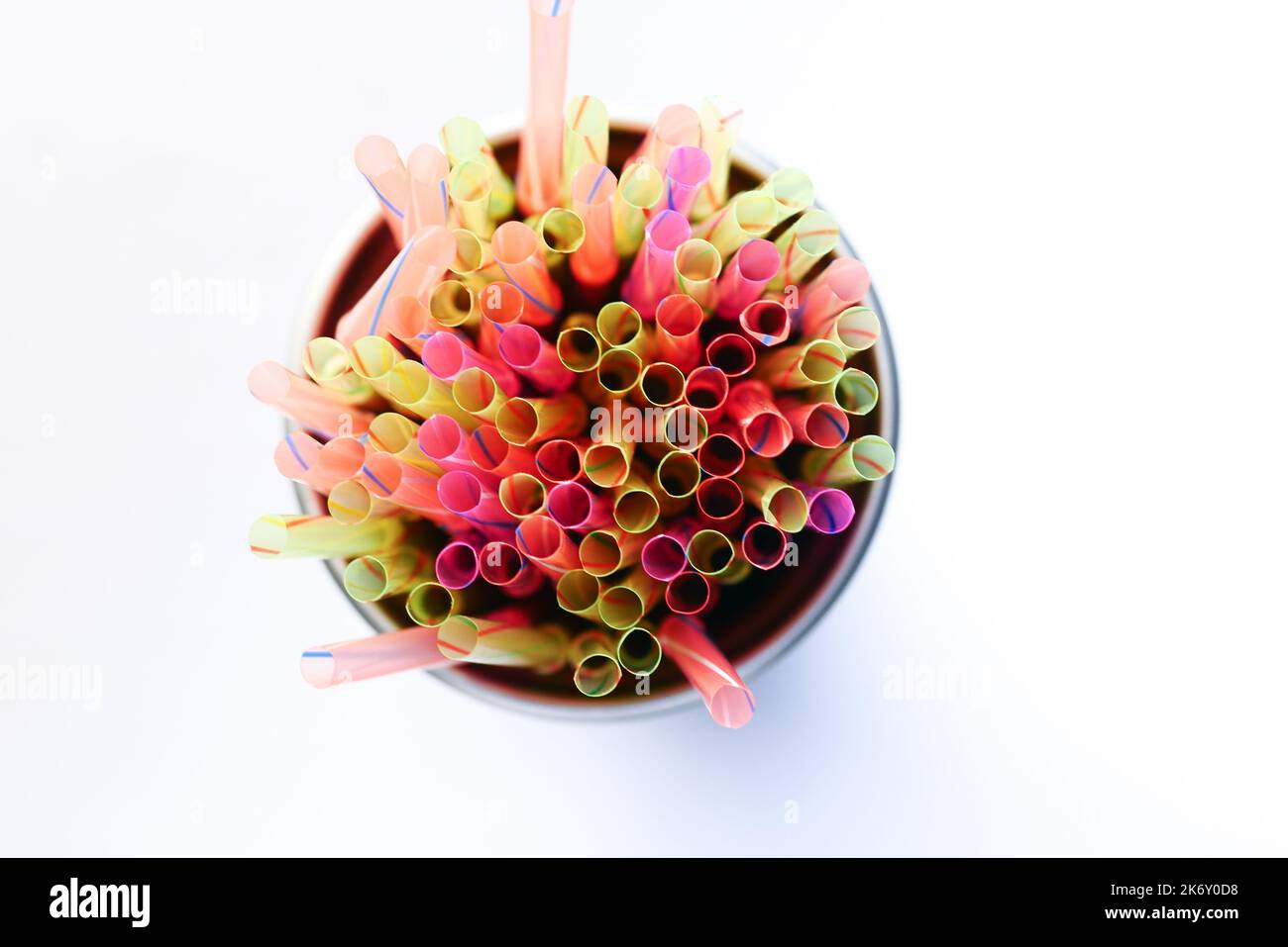 Colored striped bright plastic straws in a jar  Stock Photo