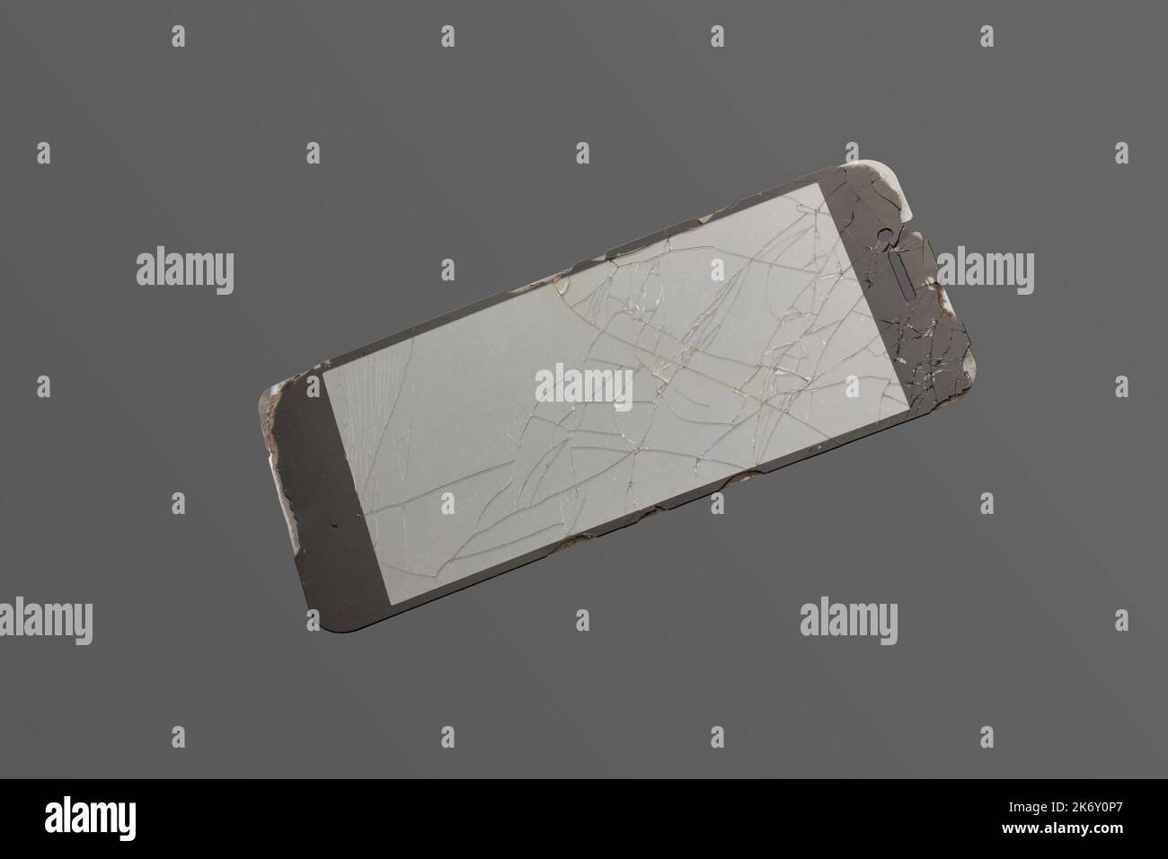 broken phone tempered glass or screen protector, old cracked smartphone protective cover isolated on neutral gray Stock Photo