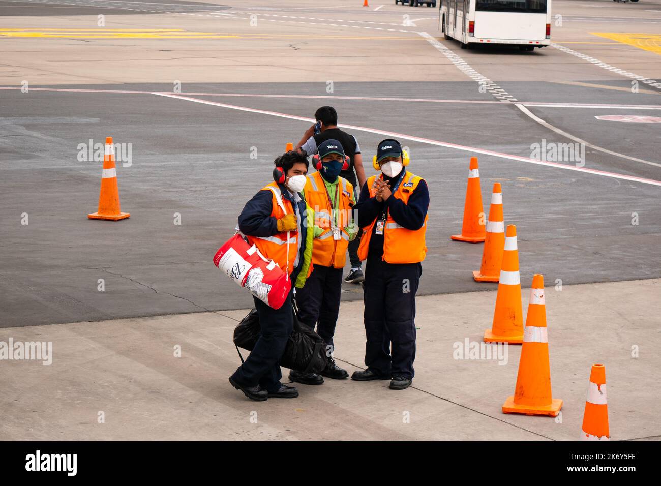 Lima, Peru - July 27 2022: Latin Men Wearing Mask and Orange Vest like the Cones Stock Photo