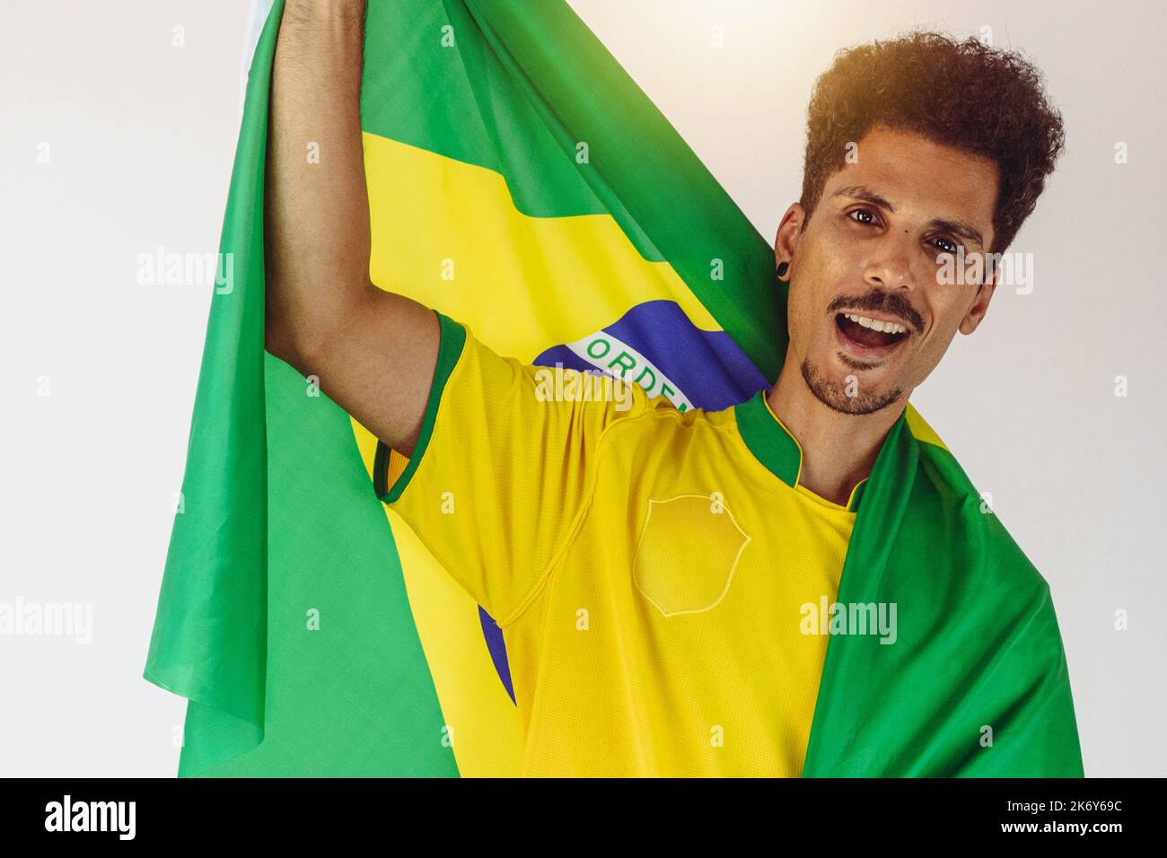 Brazilian Black Man Fan with Soccer Team Shirt Isolated on White. Sport