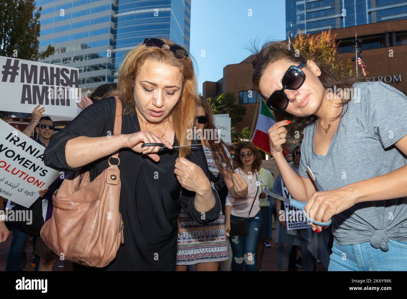 Portland, United States. 15th Oct, 2022. Two women are seen cutting