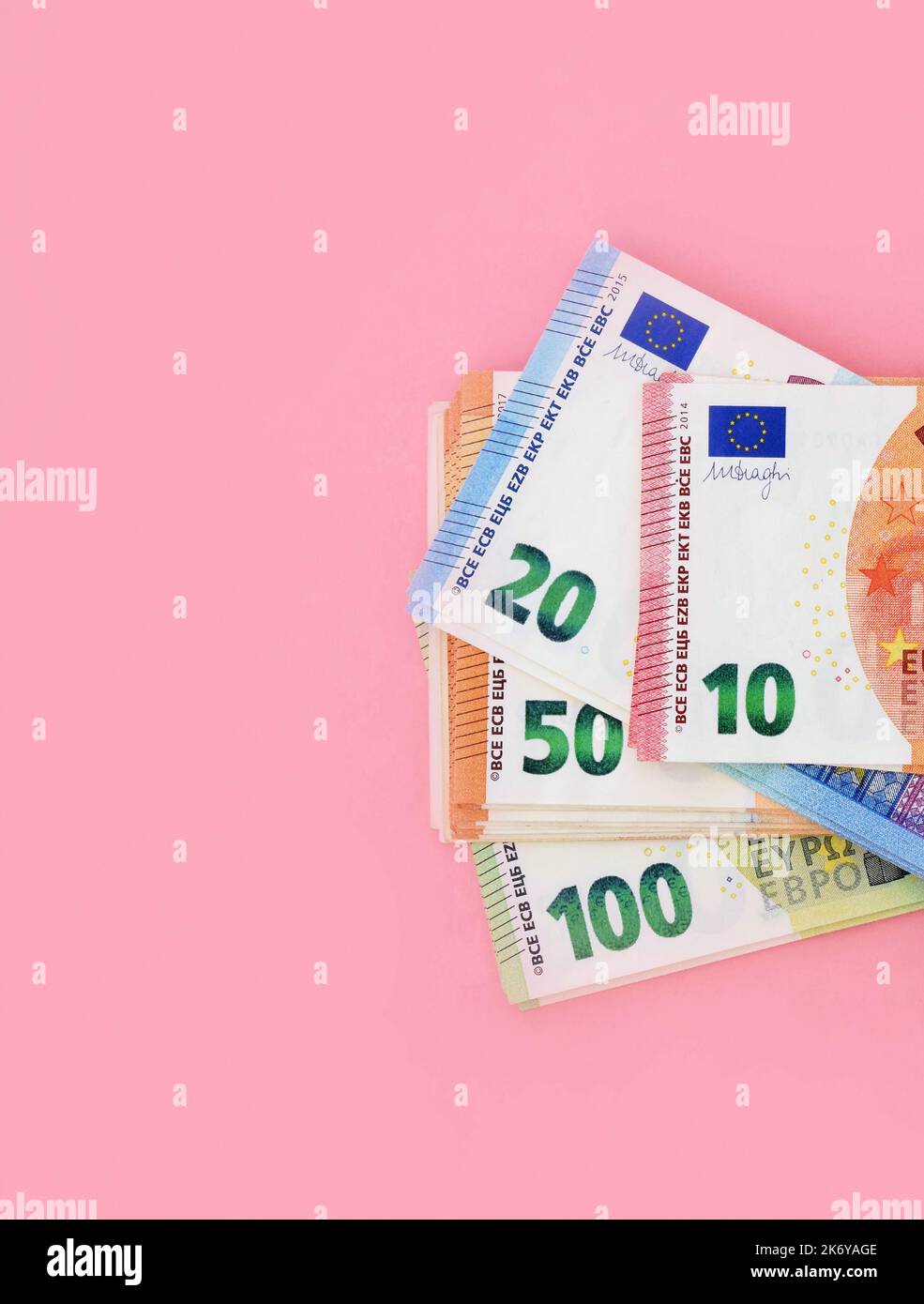 Pack of euro banknotes. 10 euro at the front and details of 20, 50, 100 at behind. Money at pink background Stock Photo