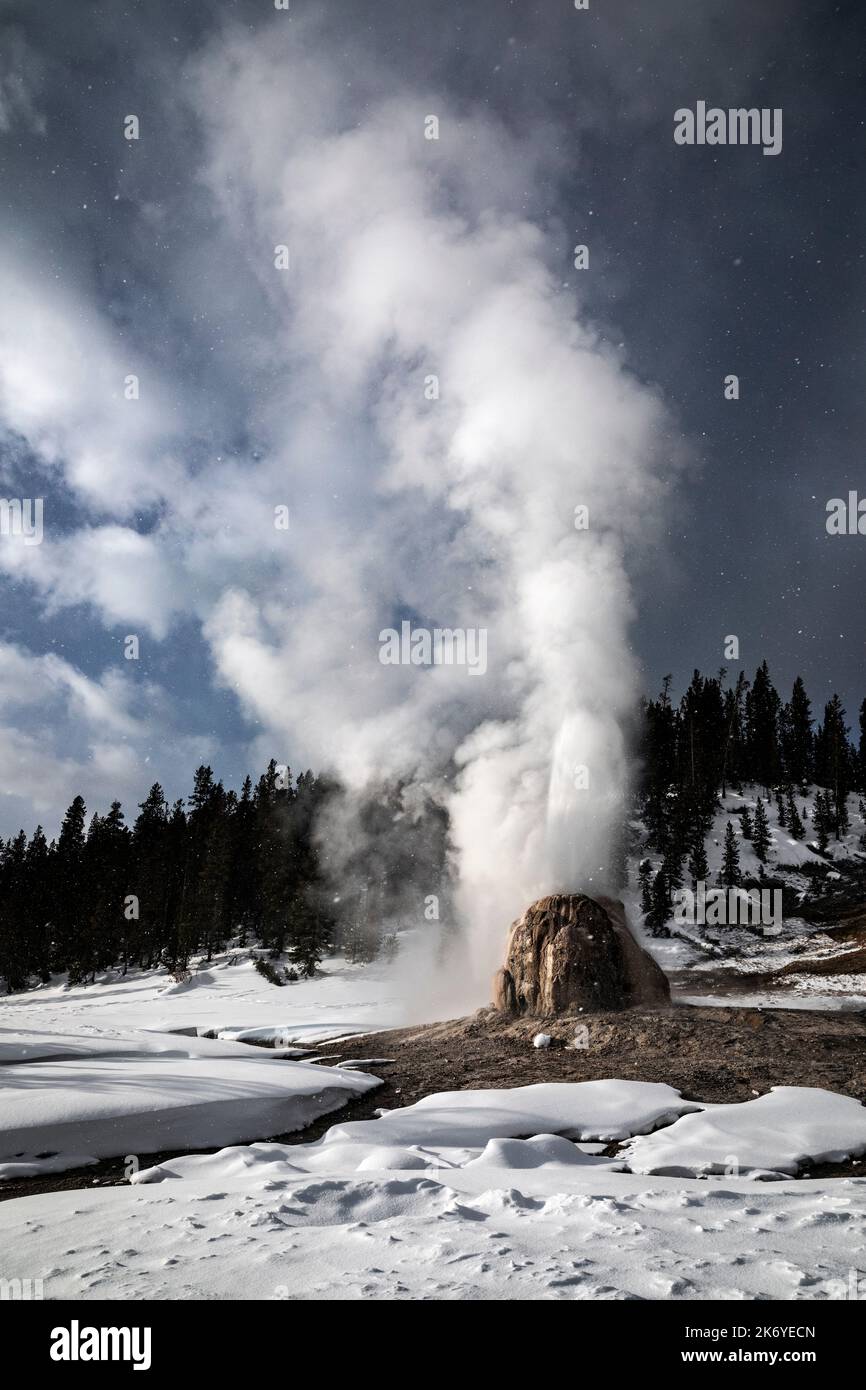 WY05090-00.....WYOMING - Lone Star Geyser erupting on a stormy winter day, Yellowstone National Park. Stock Photo