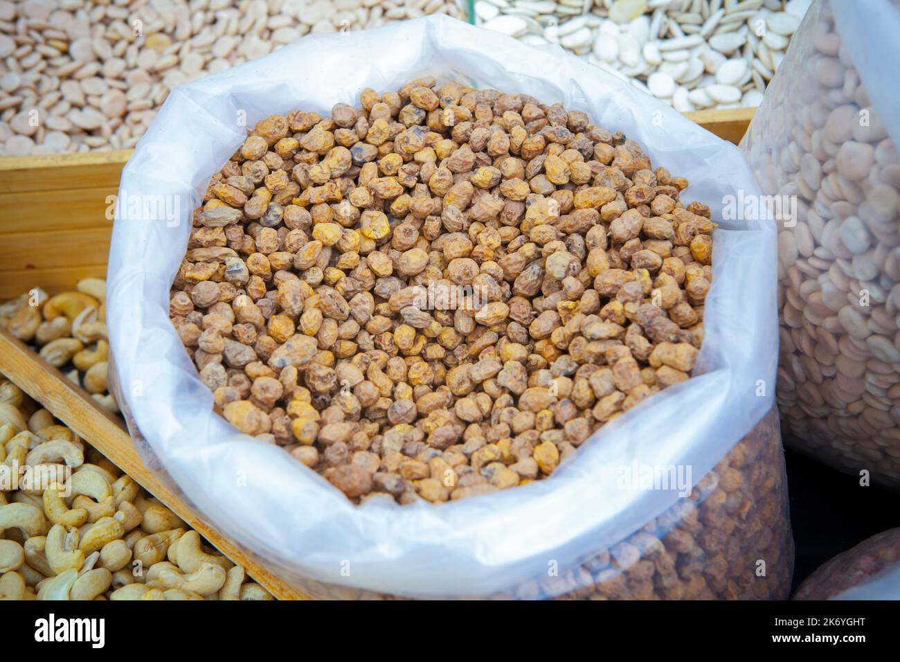Rolled up sack full of tiger nuts or chufas. Displayed at street market stall Stock Photo