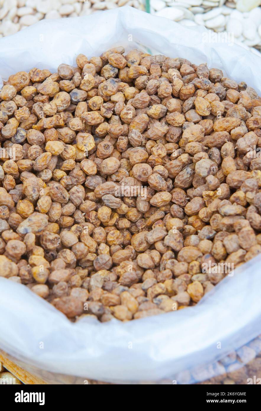 Rolled up sack full of tiger nuts or chufas. Displayed at street market stall Stock Photo