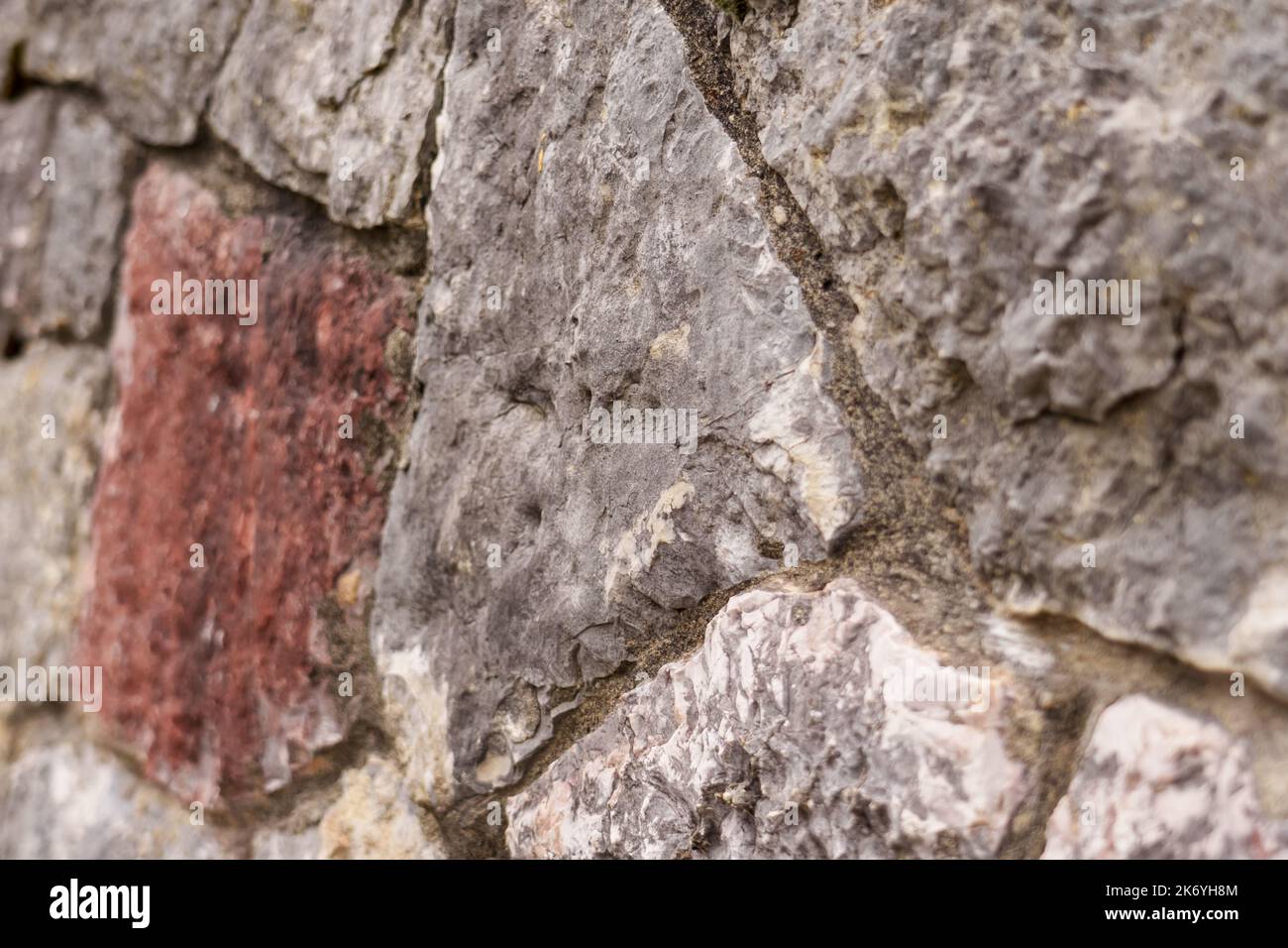 Stone wall. Uneven rough rock surface. Abstract background Stock Photo