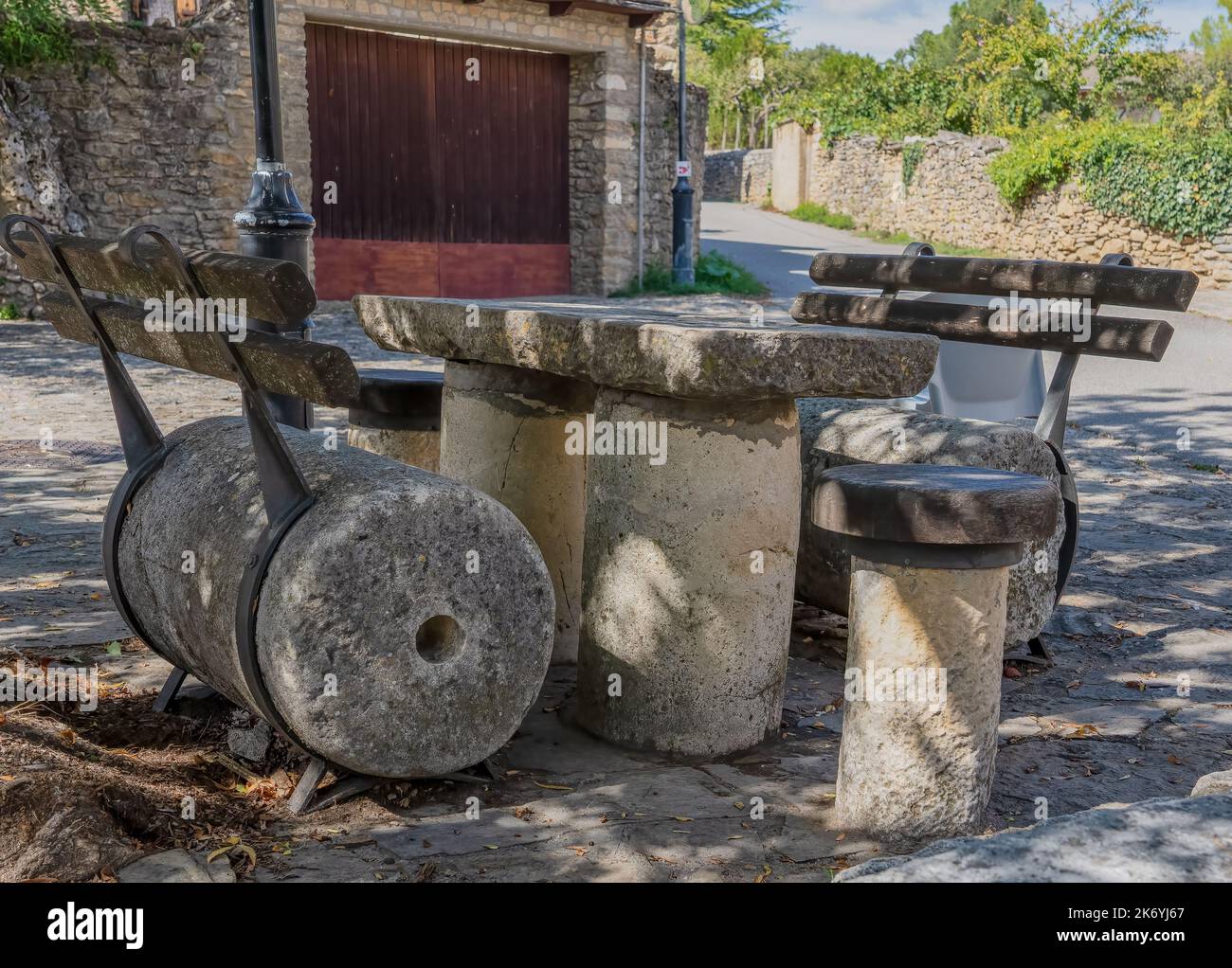shaded seating and table fashioned from old mill stone pieces in a