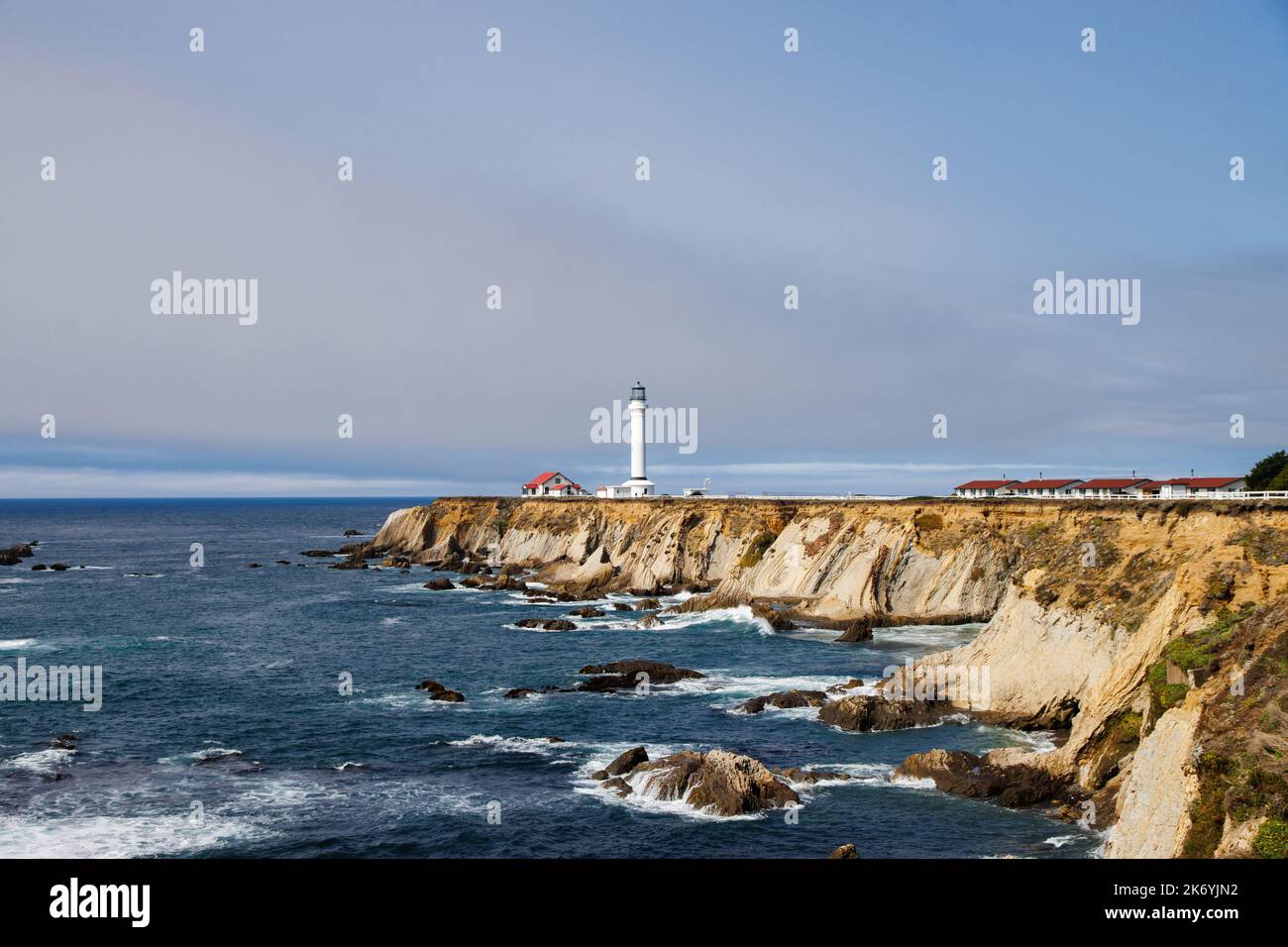 View of Point Arena Lighthouse on a rocky seashore in California by