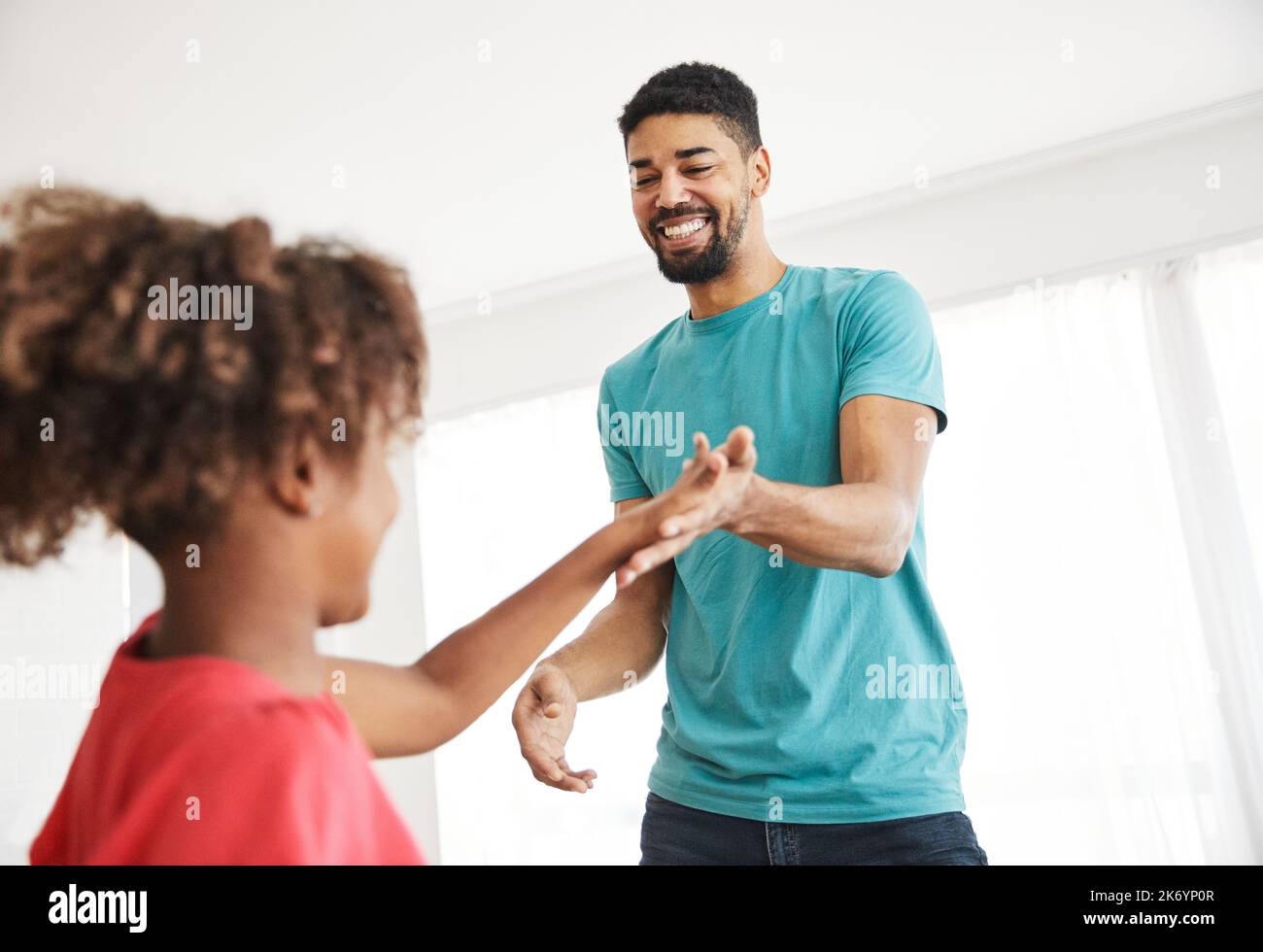 child daughter father family happy playing kid childhood dancing parent home woman girl bonding fun cheerful Stock Photo