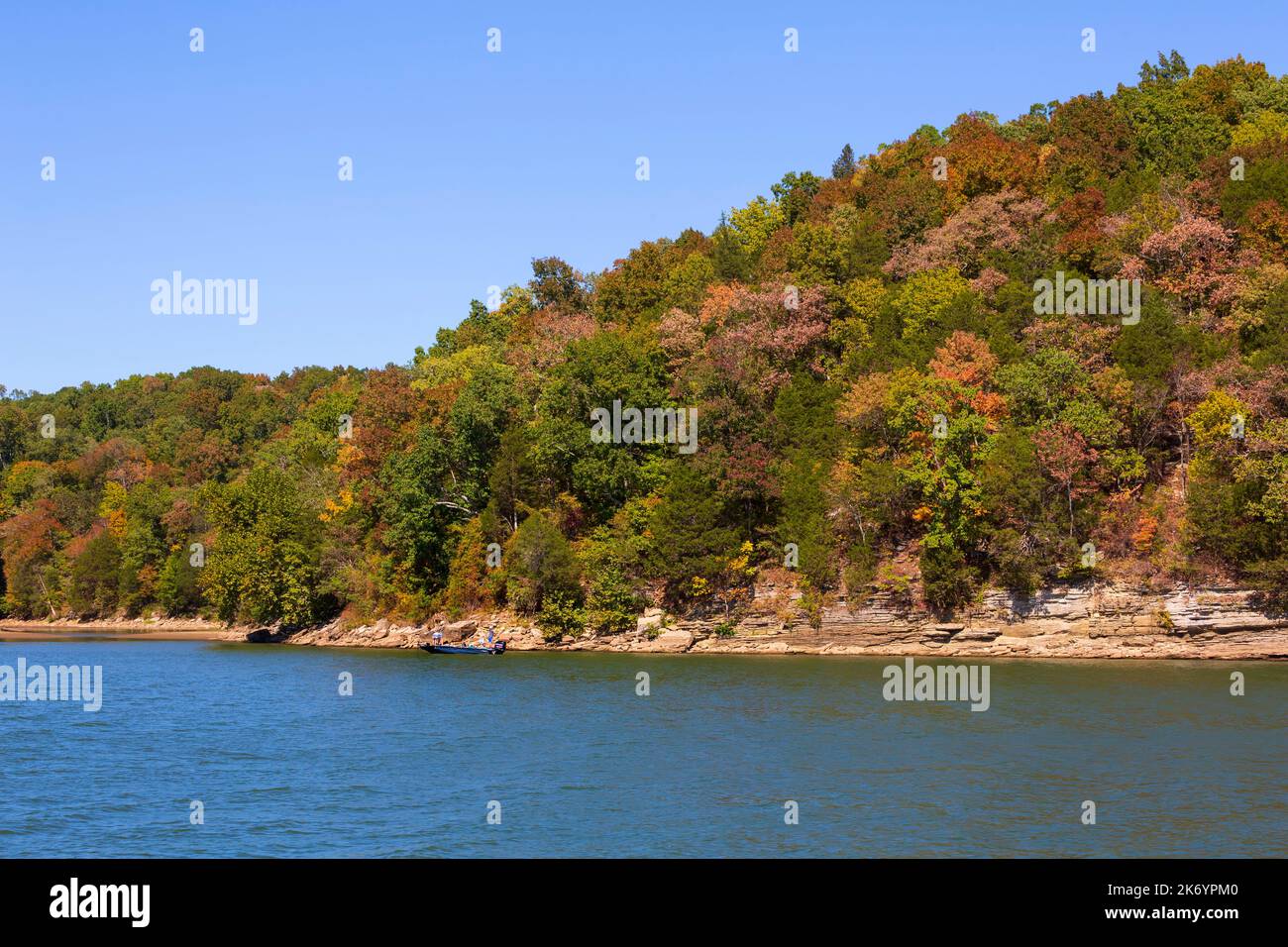 Autumn colour on the Tennessee River. Two people fish close to shore in early October. Stock Photo