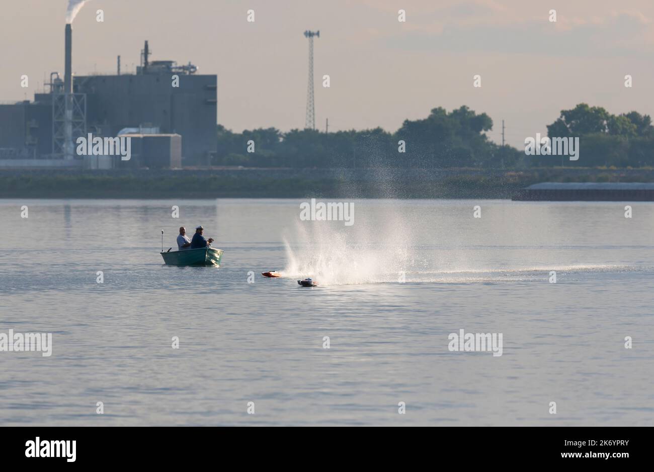 Two men race high speed remote controlled boats on the Mississippi River near Muscatine, Iowa Stock Photo