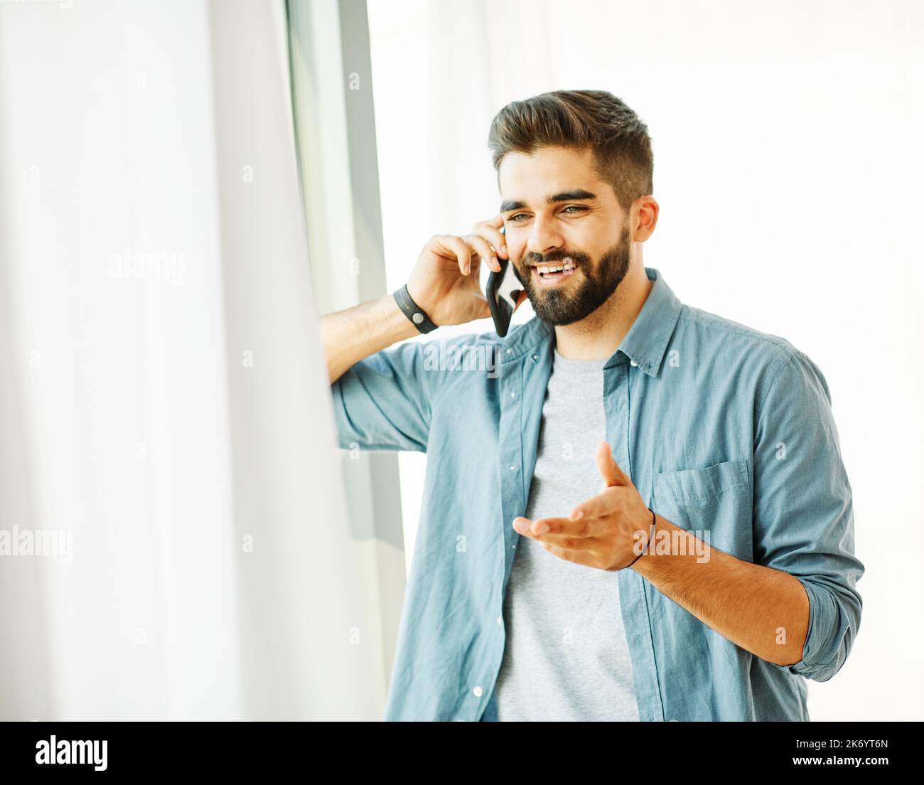 portrait man phone smartphone cell mobile using model male young happy lifestyle handsome smiling shirt casual Stock Photo