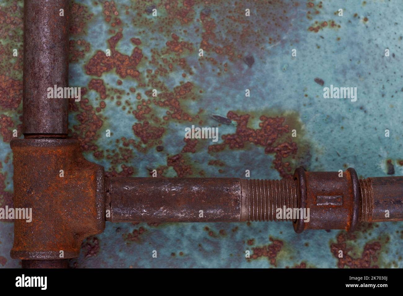 Old rusty valve pipes on rusty metal wall background Stock Photo - Alamy