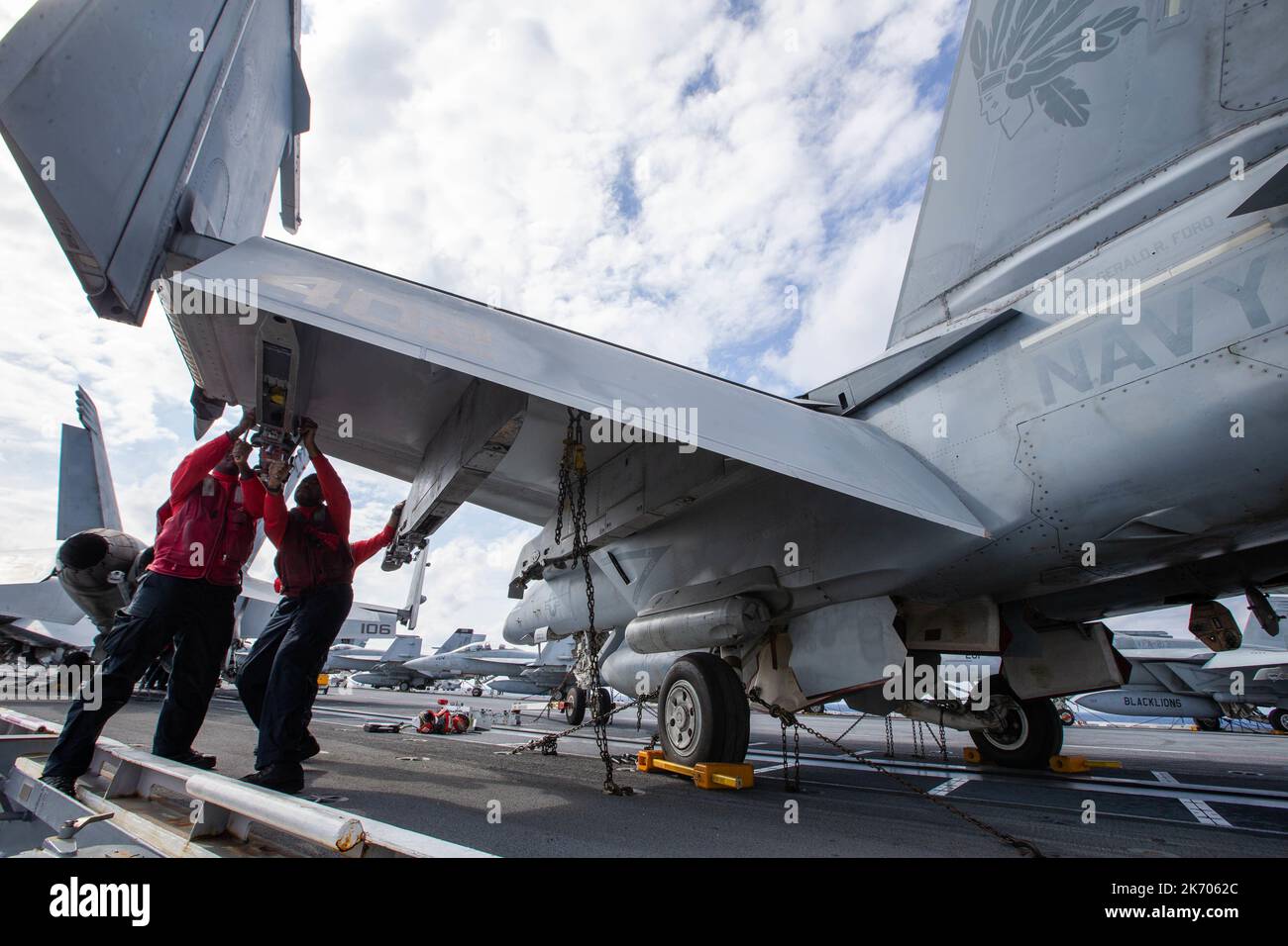 Sailors assigned to the “Golden Warriors” of Strike Fighter Squadron (VFA) 87 install weapon suspension equipment onto an F/A-18E Super Hornet on the first-in-class aircraft carrier USS Gerald R. Ford’s (CVN 78) flight deck, Oct. 9, 2022. The Gerald R. Ford carrier Strike Group (GRFCSG) is deployed in the Atlantic Ocean, conducting training and operations alongside NATO Allies and partners to enhance integration for future operations and demonstrate the U.S. Navy’s commitment to a peaceful, stable and conflict-free Atlantic region. (U.S. Navy photo by Mass Communication Specialist 2nd Class Za Stock Photo