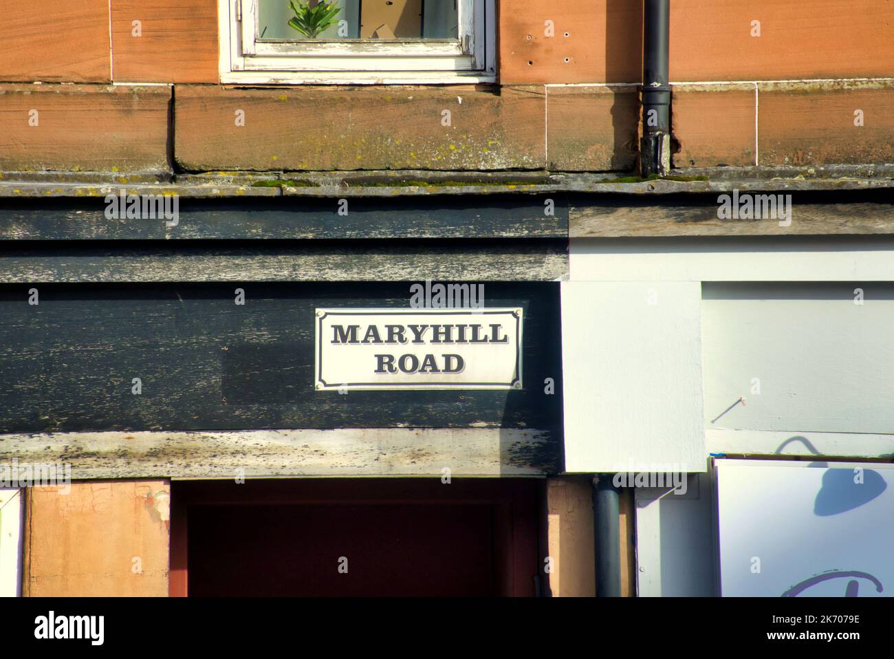Maryhill road street sign on red sandstone tenement above head height Stock Photo Alamy