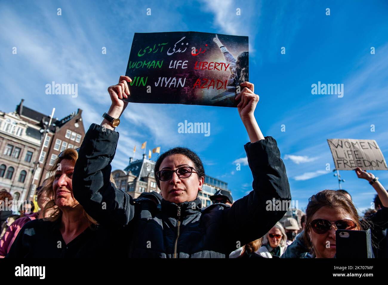 An Iranian woman is seen holding a placard with the three words that have become a symbol of these protests. Because today marks a month since the death in custody of Mahsa Amini, who was detained by the morality police for allegedly wearing her headscarf too loosely, the Kurdish, Iranian and Afghan diasporas called for a rally in the city center to protest against the Islamic Regime and the general oppression of women. Inside Iran, protests keep continuing, despite a brutal crackdown by authorities that Iranians for Justice and Human Rights activists claim have taken more than 200 lives. Stock Photo