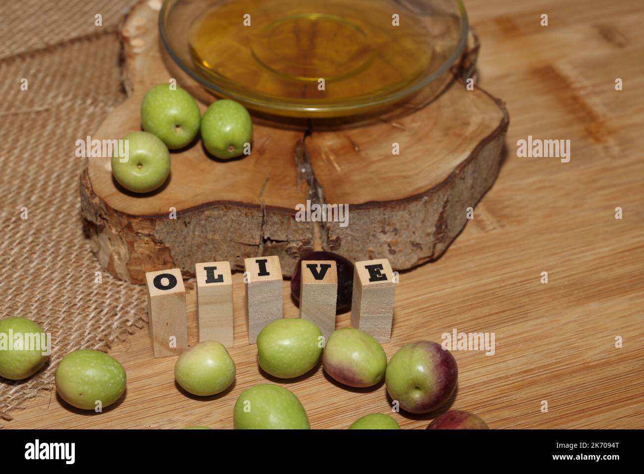 Olives and Olive Oil on wooden background Stock Photo - Alamy